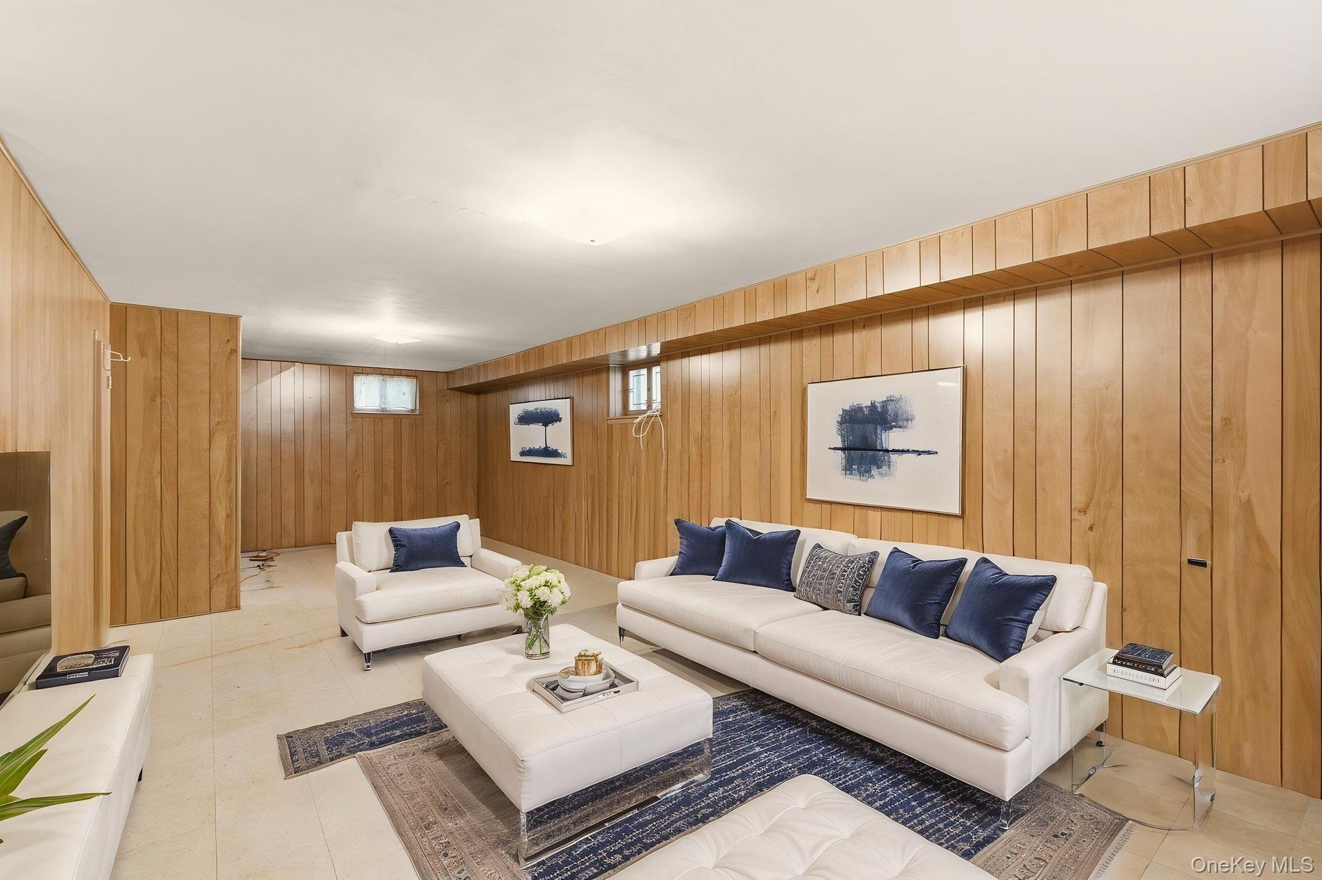 Wood-paneled walls with integrated door, recessed ceiling lighting, and light-toned flooring