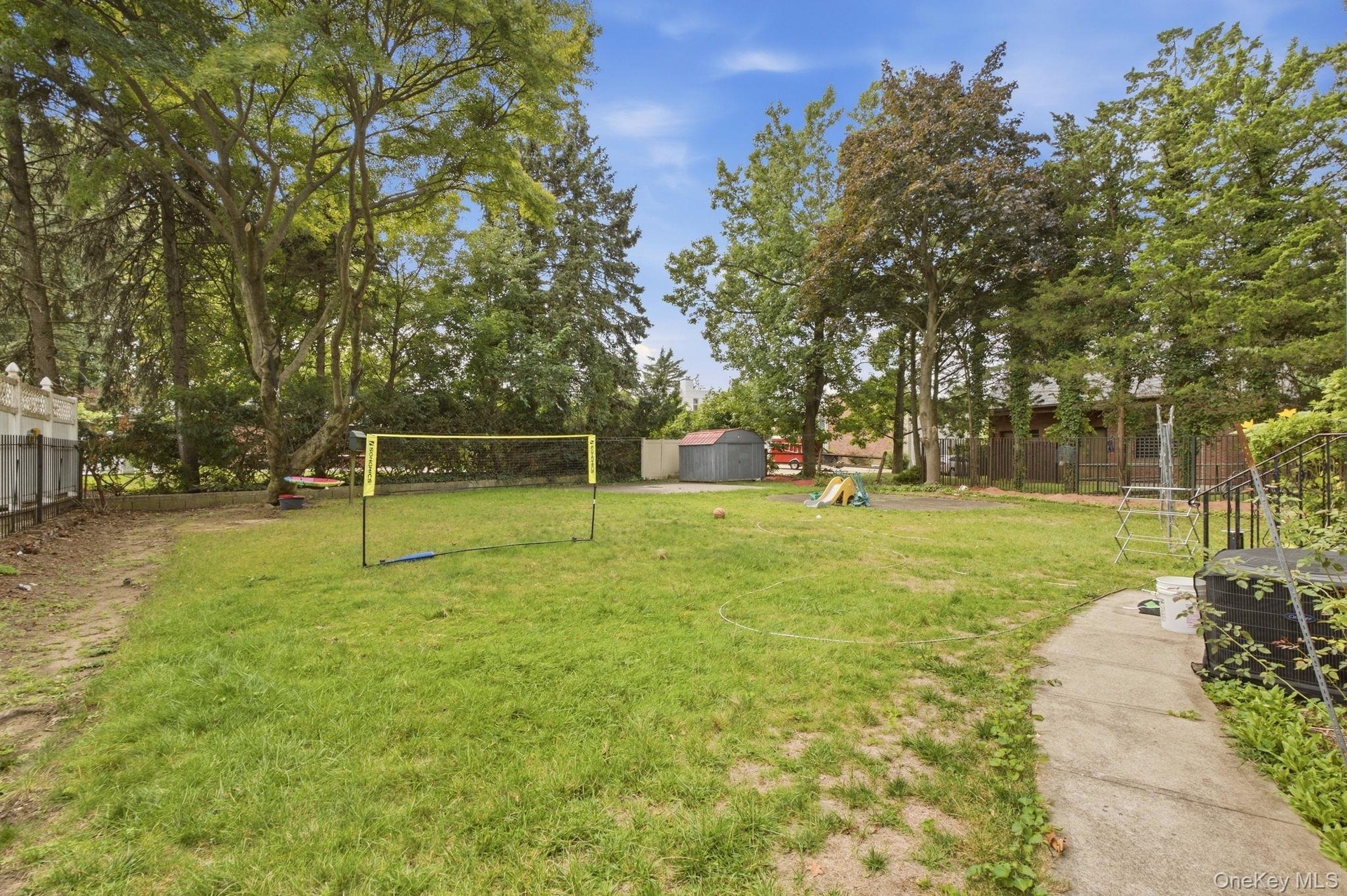 Expansive grassy yard with mature trees