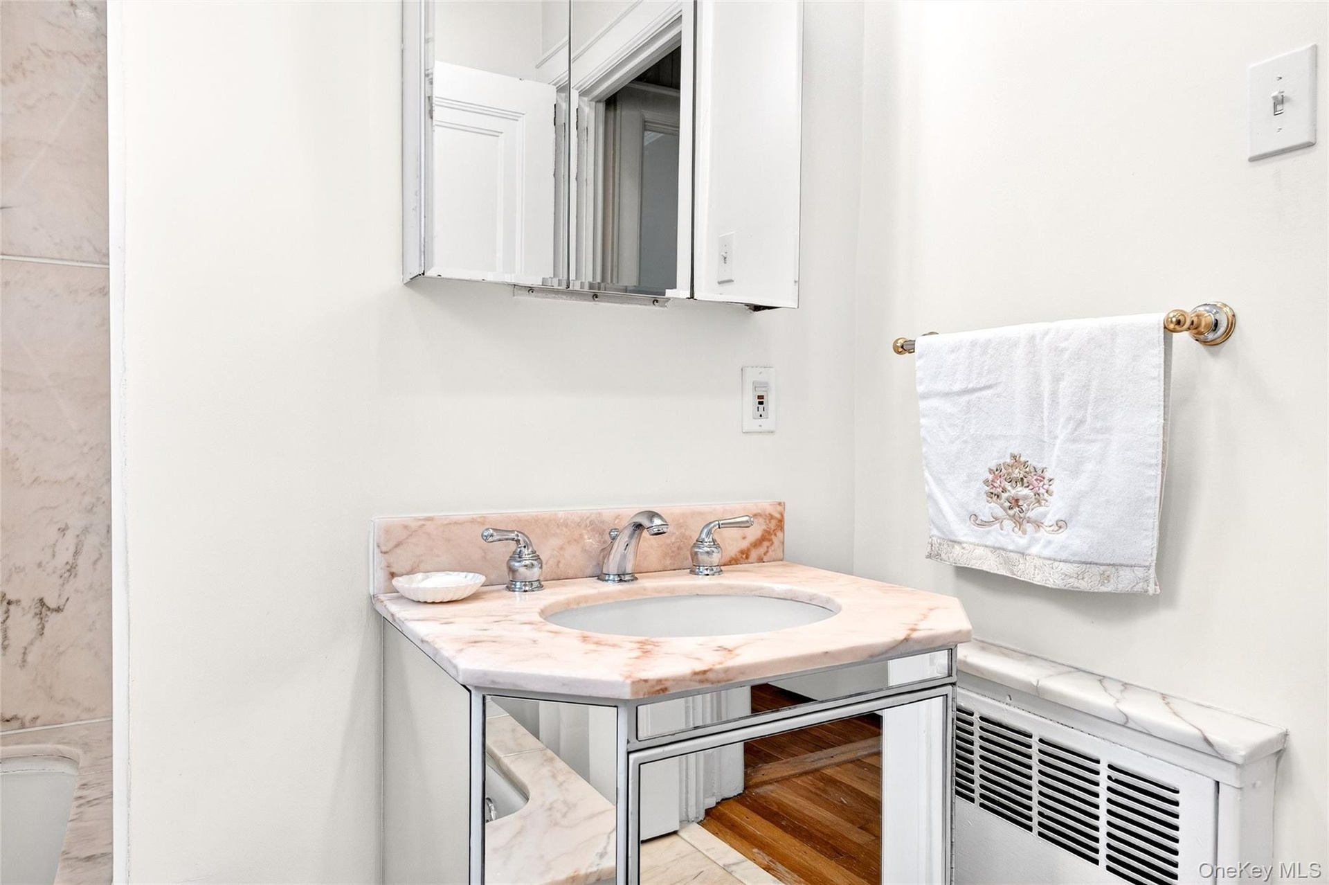 Full bath with a sink and radiator