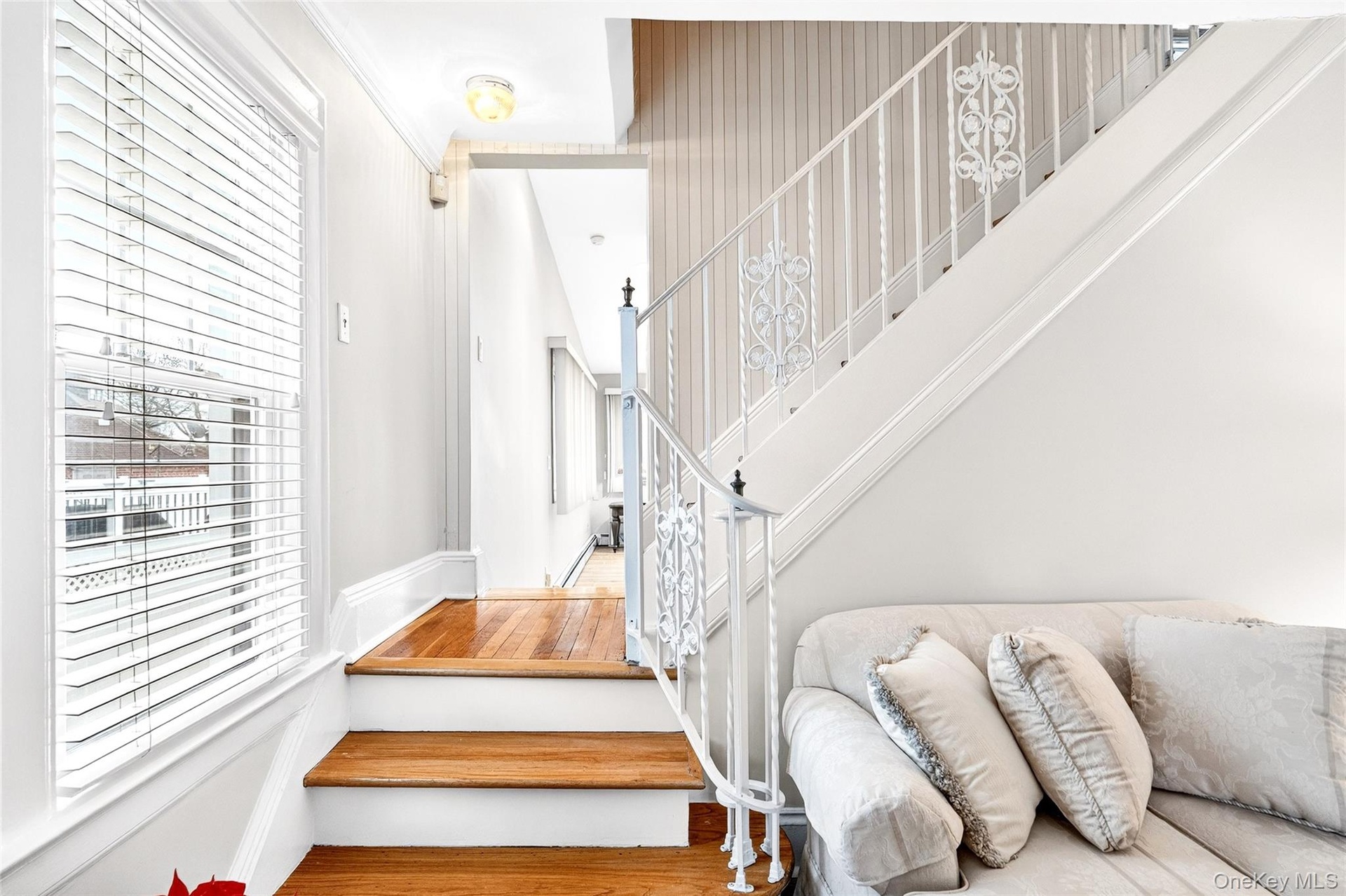 Staircase featuring plenty of natural light and wood finished floors