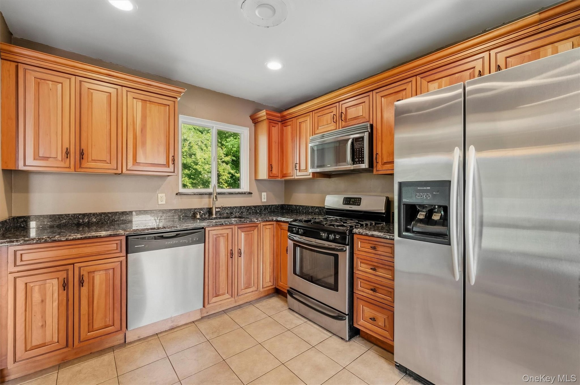 Updated eat in kitchen accented with stainless steel appliances.