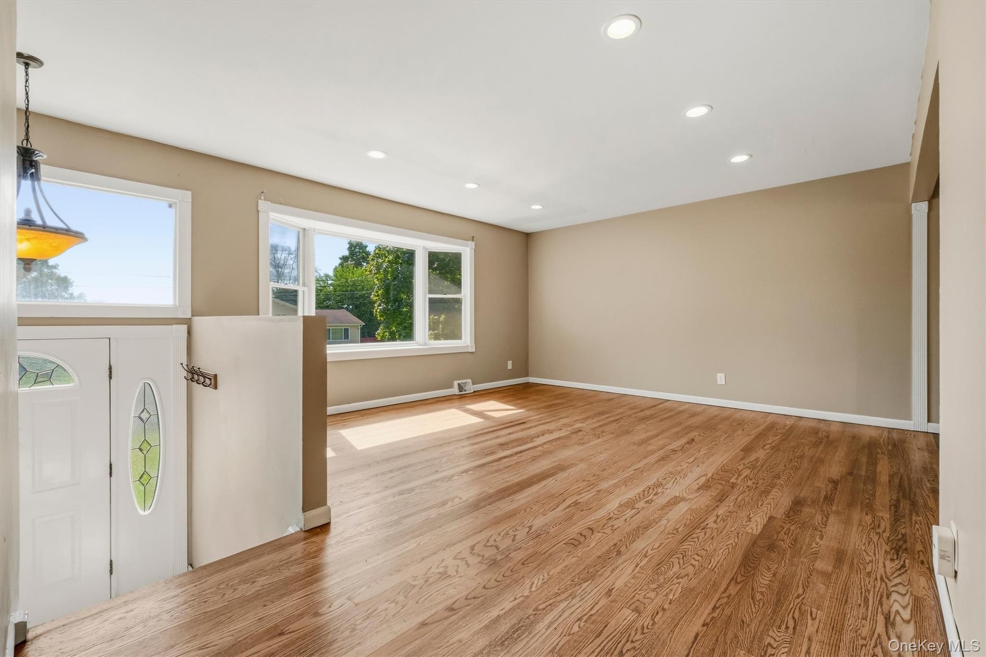 The spacious, sun filled living room features an oversized picture window.