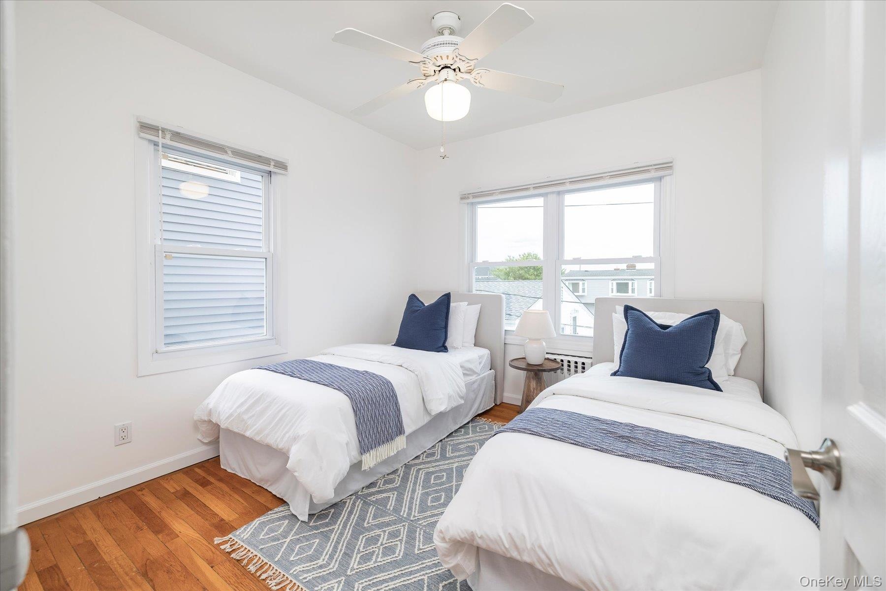 Bedroom with hardwood floors and lots of natural light