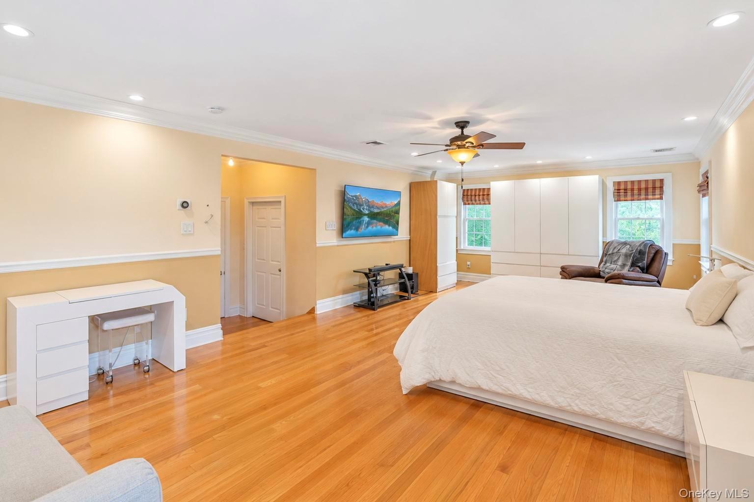 Wood-finish flooring throughout, with crown molding and recessed lighting
