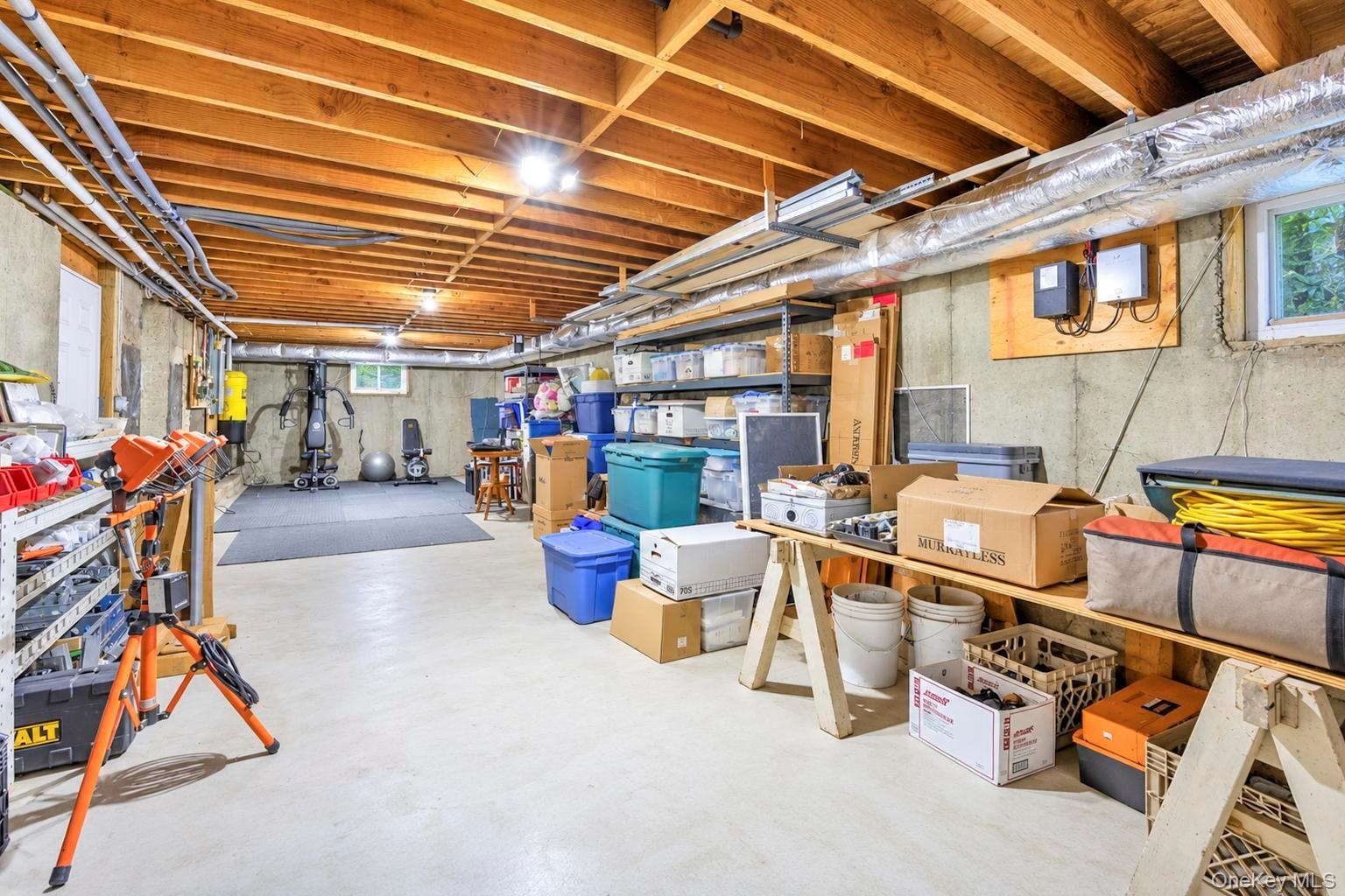Great storage, exposed wood ceiling beams, concrete walls, painted concrete flooring, and an egress window