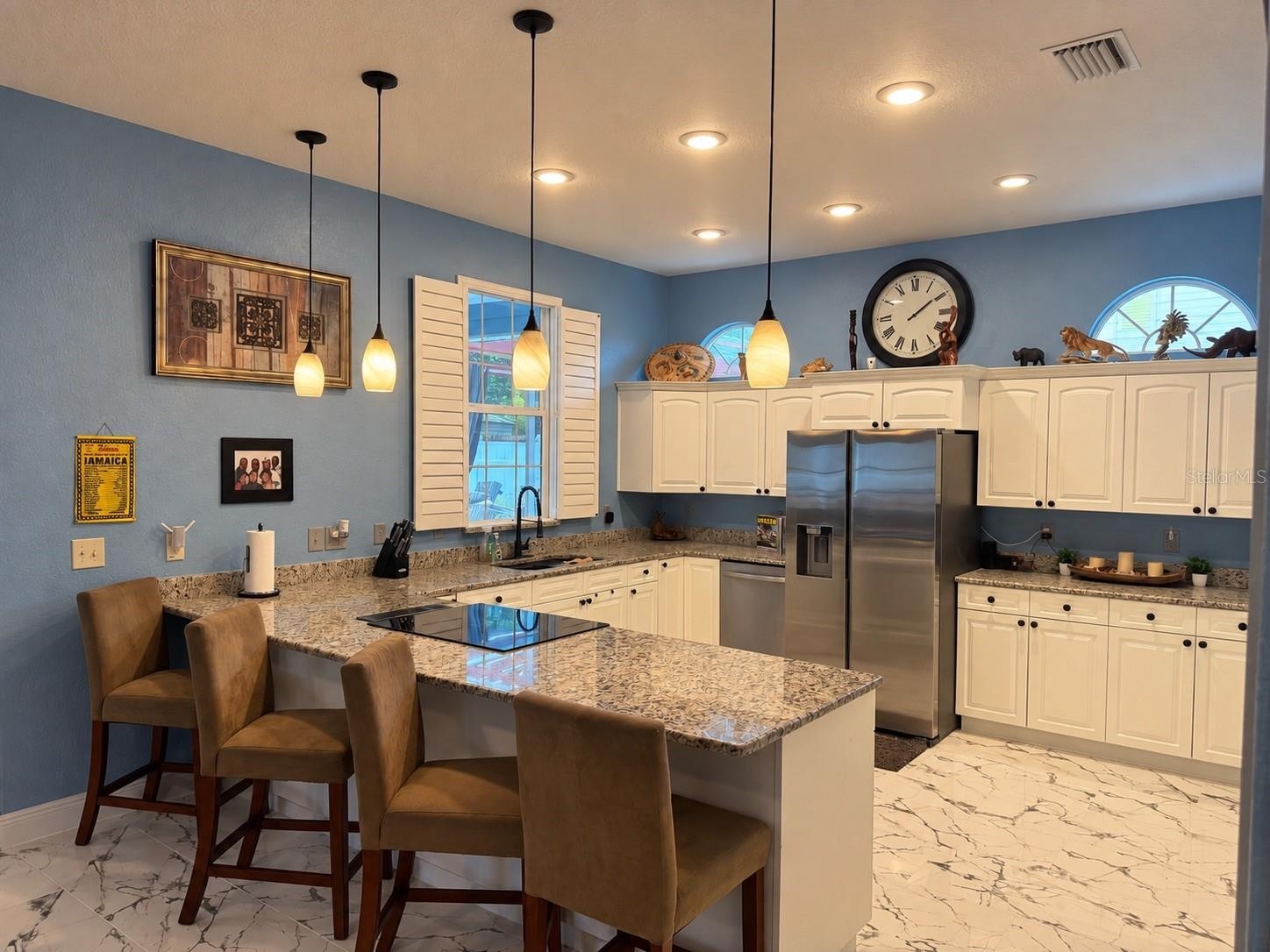 Backyard view from the kitchen sink, stainless steel appliances, granite counters, eat in kitchen