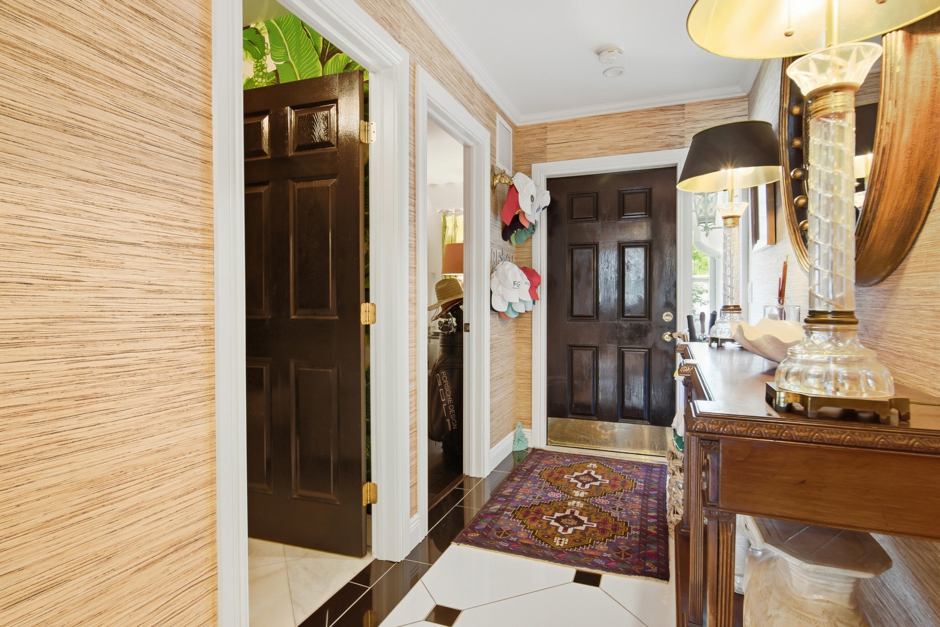 Entryway featuring a paneled door, wood-finish console table, and patterned floor tiles