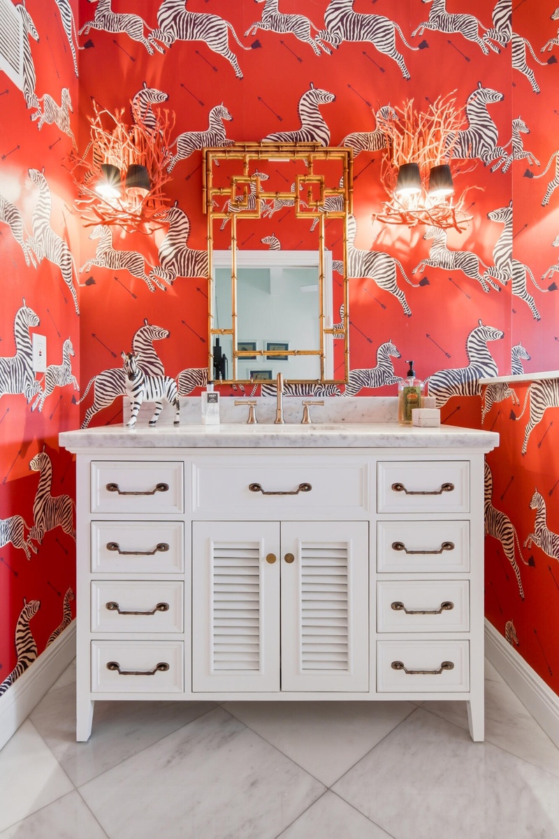 White vanity with ample drawer storage, louvered cabinet doors, and a light-toned countertop