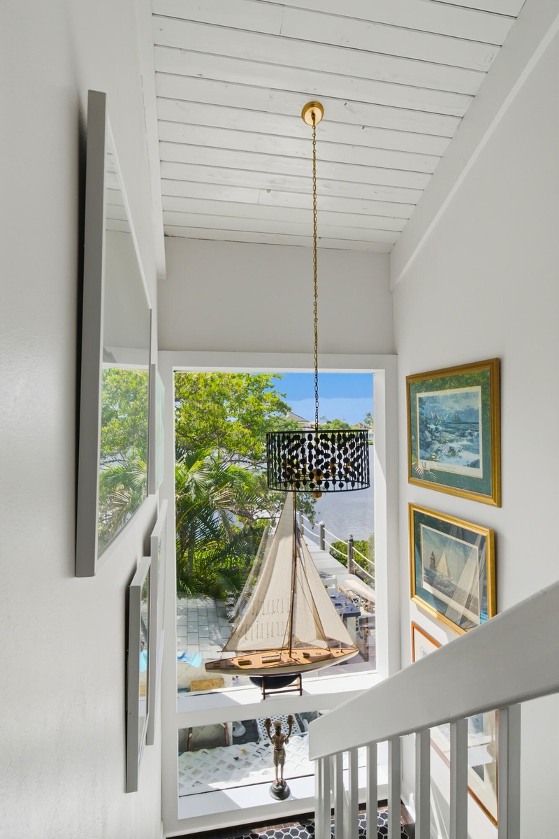 White painted wood plank ceiling with a central pendant fixture