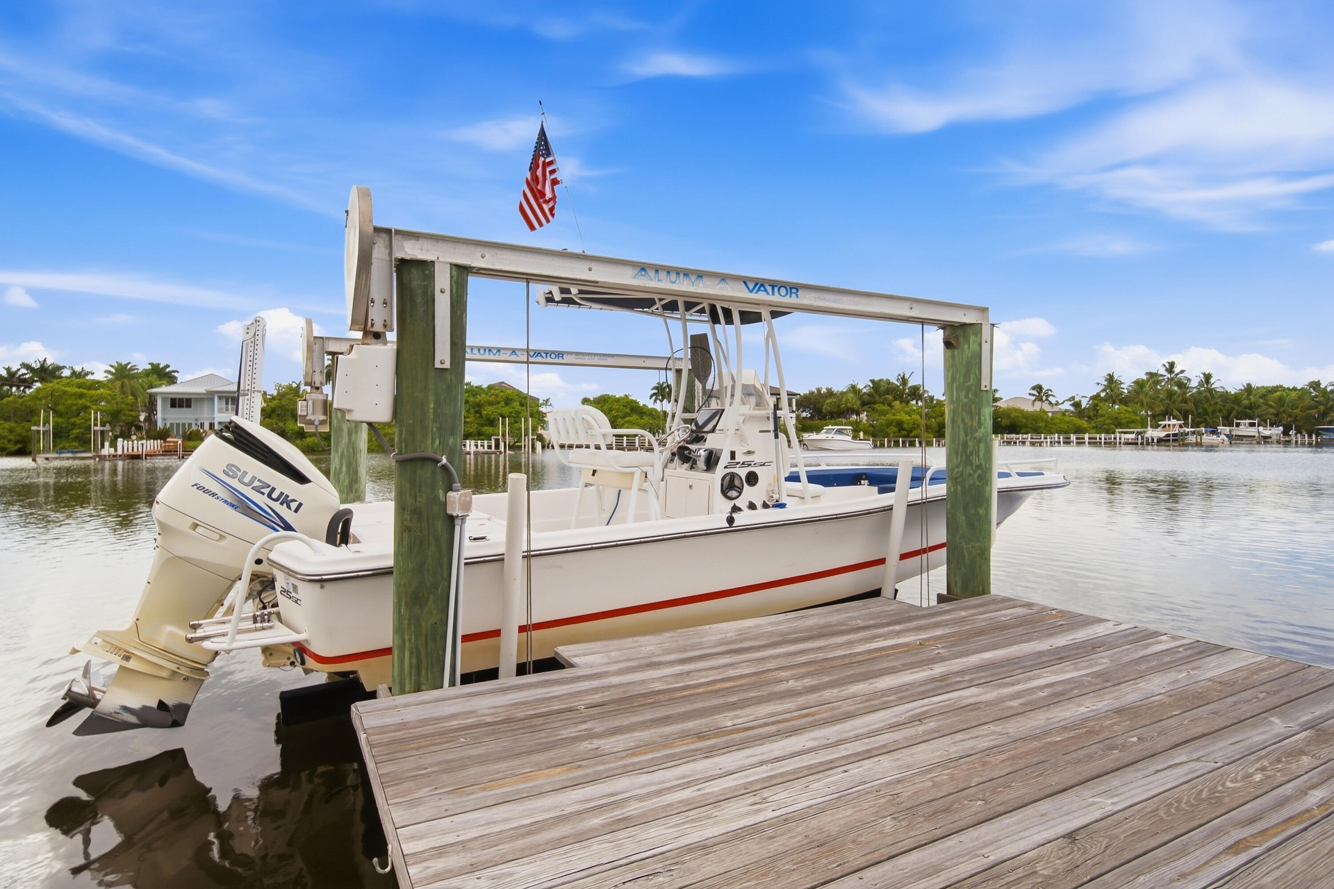 Wood-finish dock with boat lift and expansive waterfront access