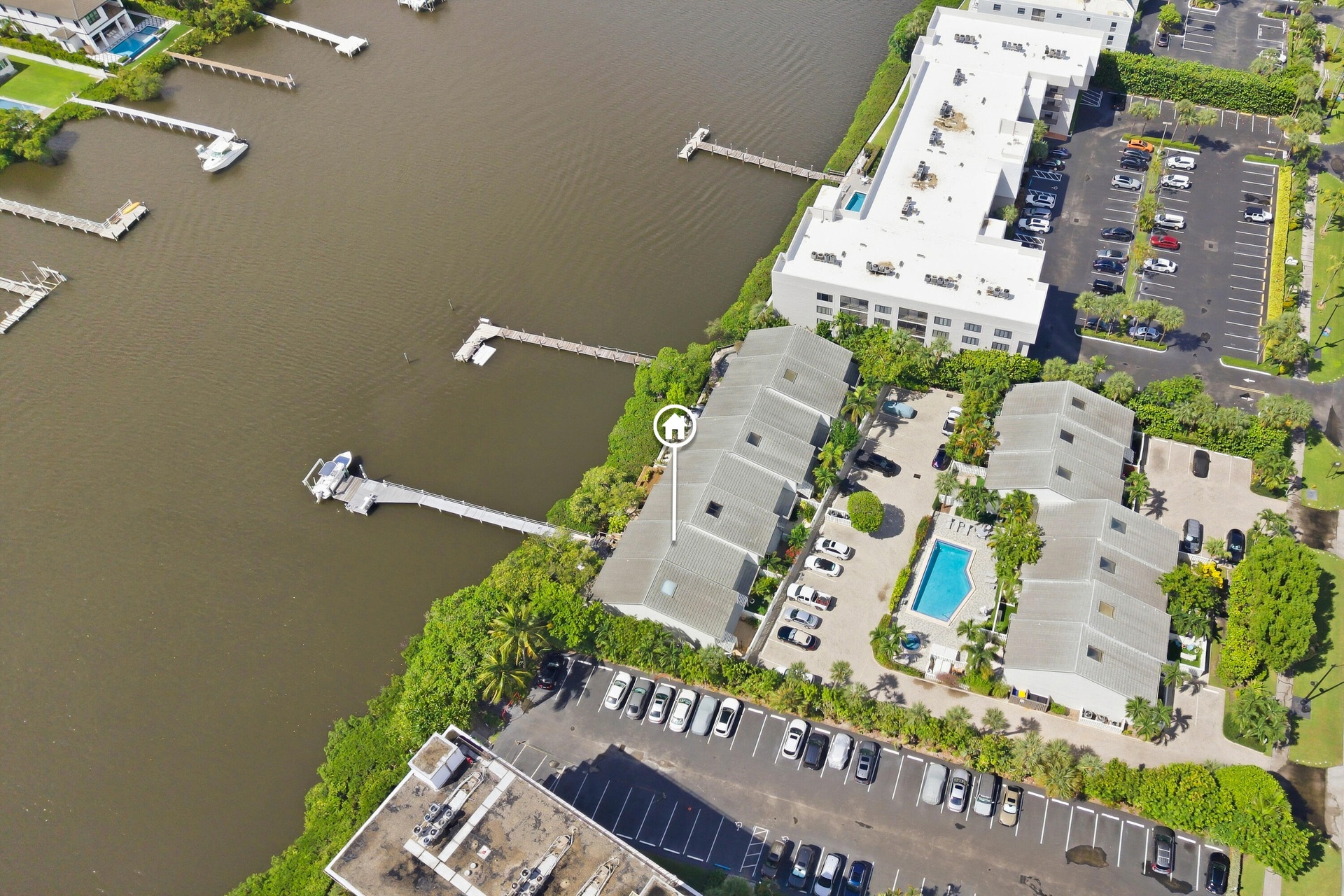 Waterfront property featuring private docks and a community swimming pool