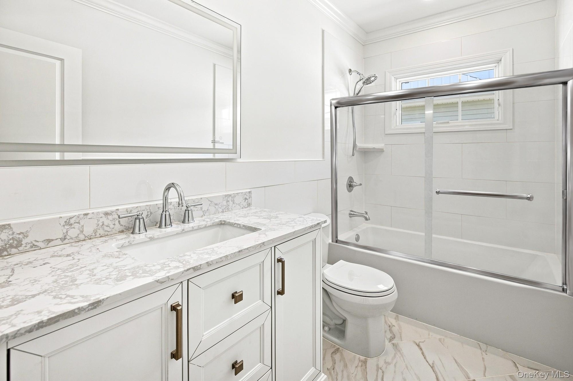 Second floor bath with white vanity with and integrated sink, complemented by stone-finish countertop