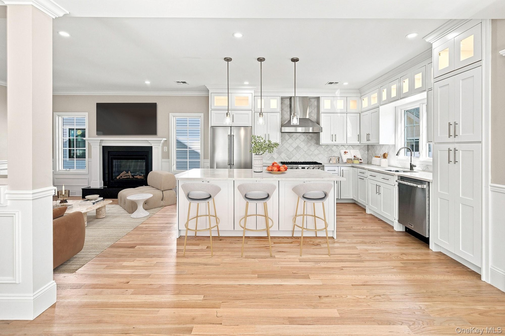 Spacious kitchen with white shaker cabinetry, stainless steel appliances, and a central island with pendant lighting.VIRTUAL STAGING