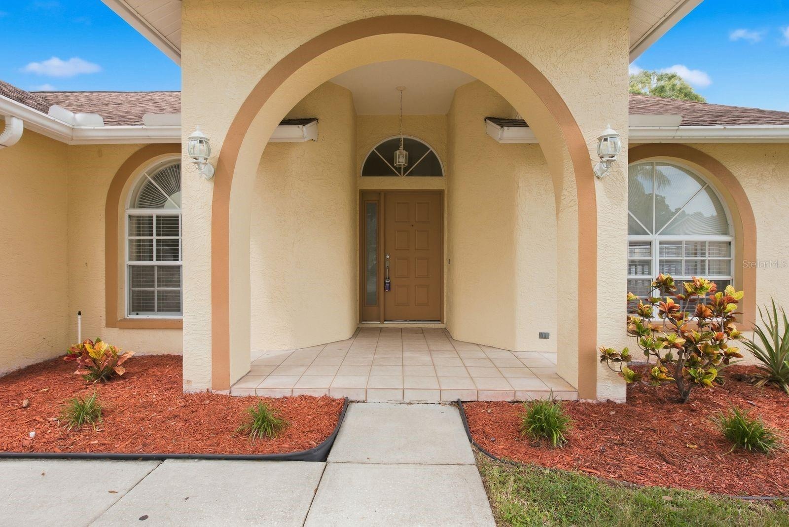 Charming arched entry welcomes you inside.