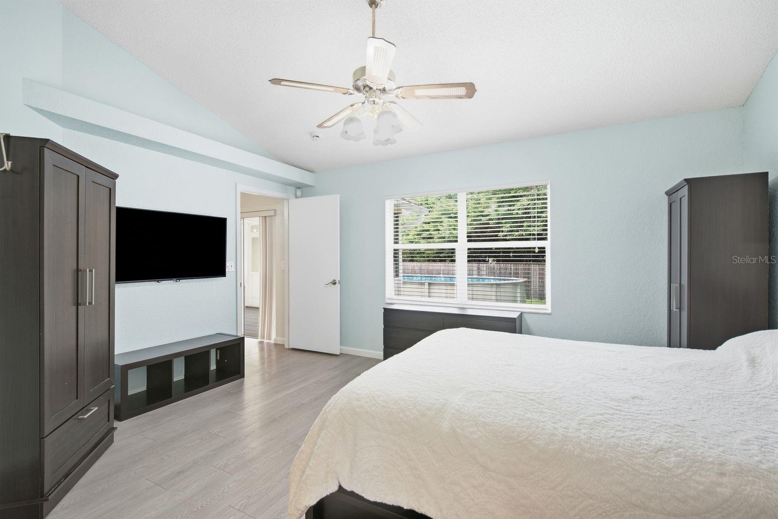 Primary bedroom with walk in closet, en suite bathroom and overlooking beautiful backyard.