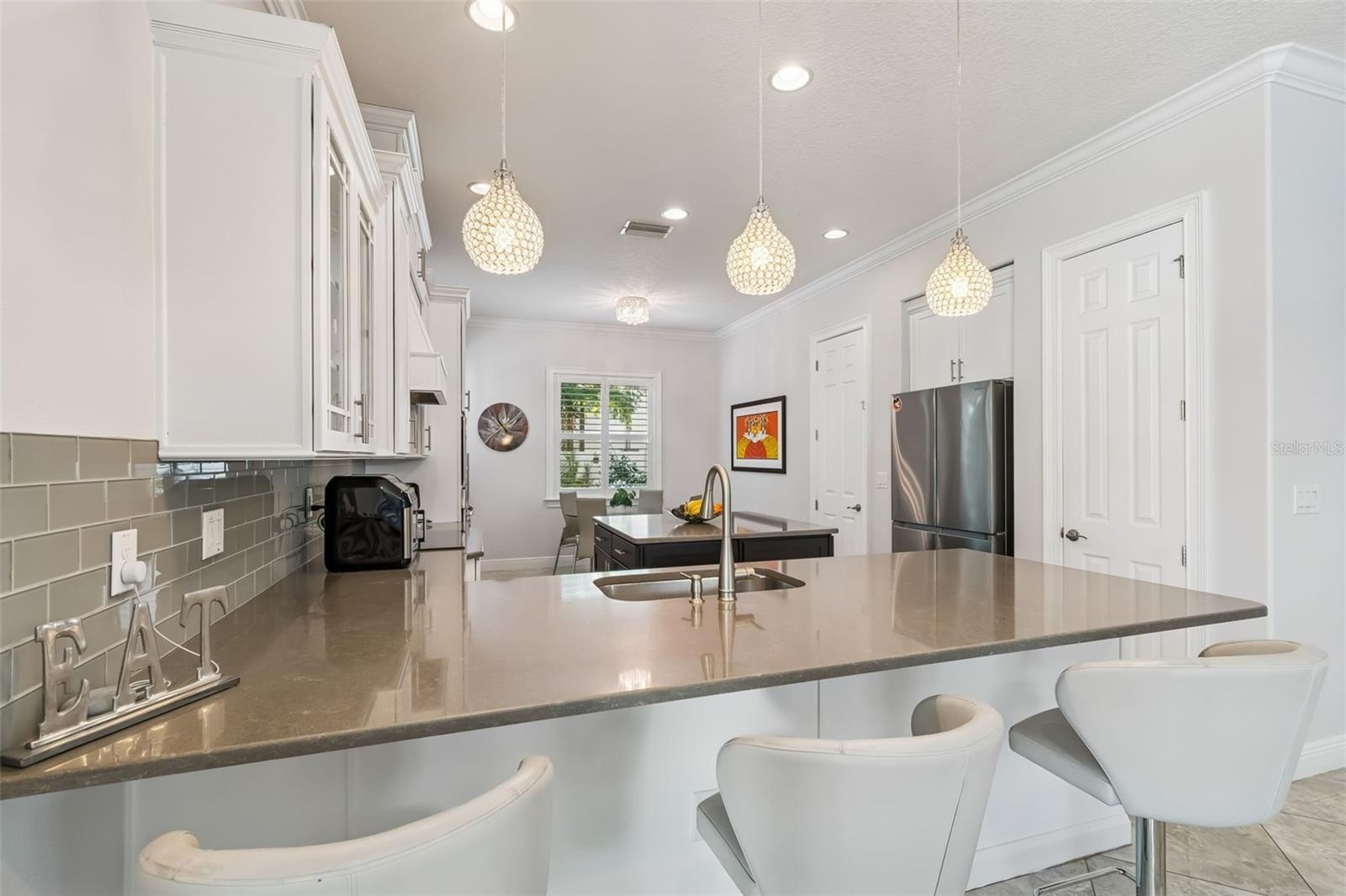 A closer look at the kitchen’s gray quartz peninsula and cabinetry.