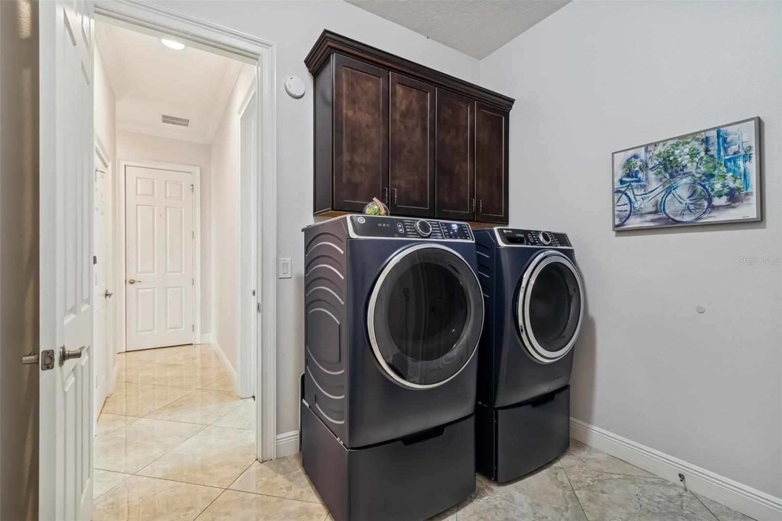 The laundry room offers a convenient transition from the three car garage into the home.