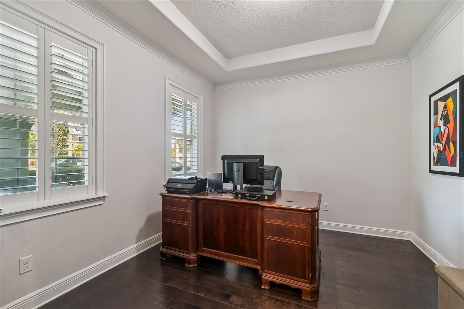 A spacious private office near the entry, set apart from the main living areas