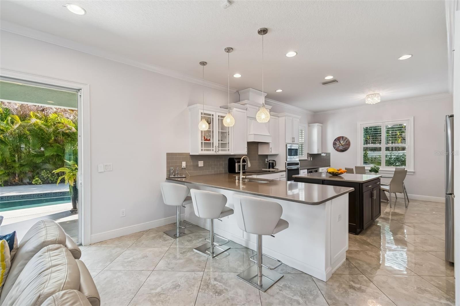 An open kitchen and living area flows through sliding doors to the backyard