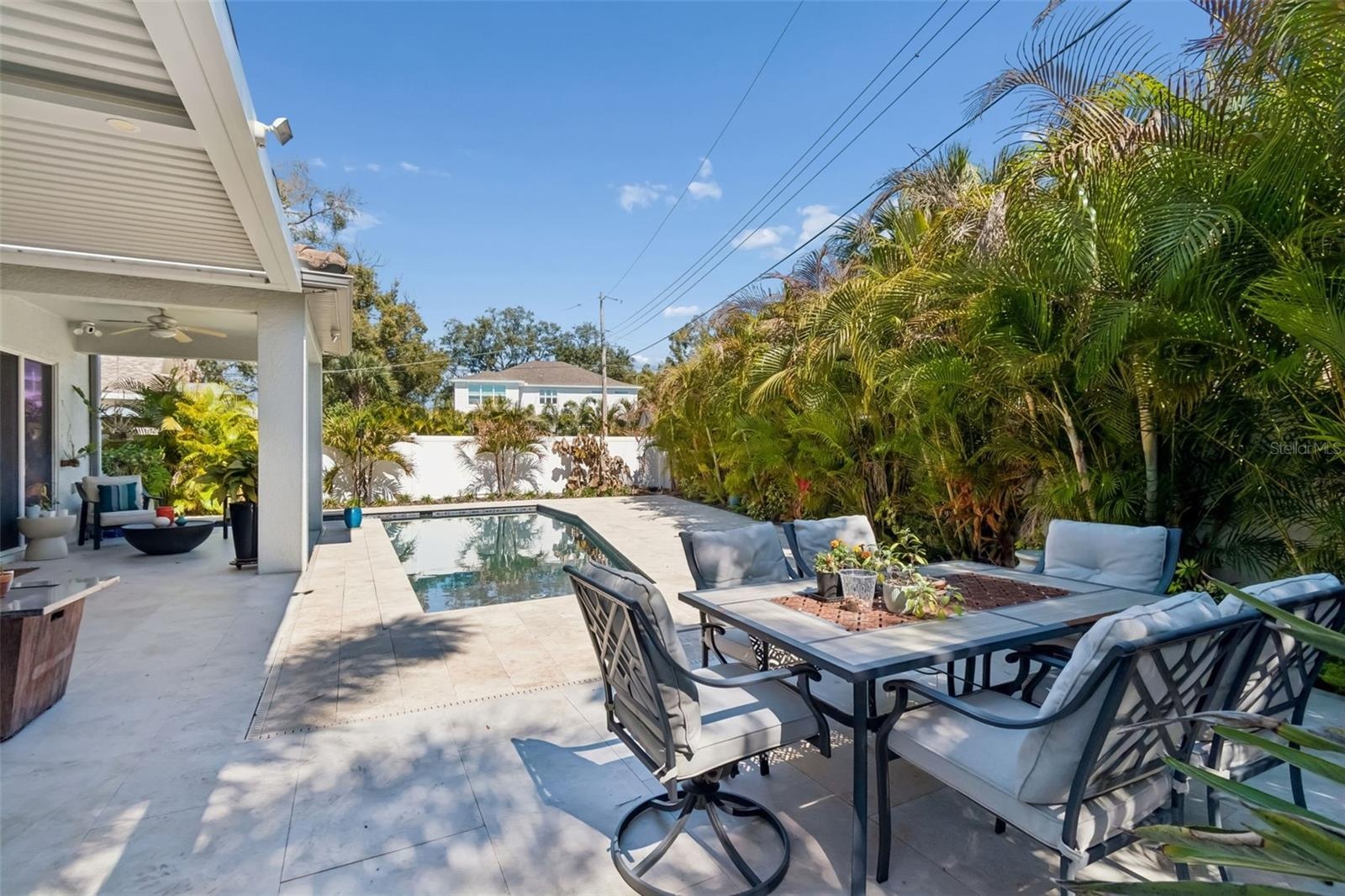 Beyond the pool, a separate outdoor dining area offers more room to gather.