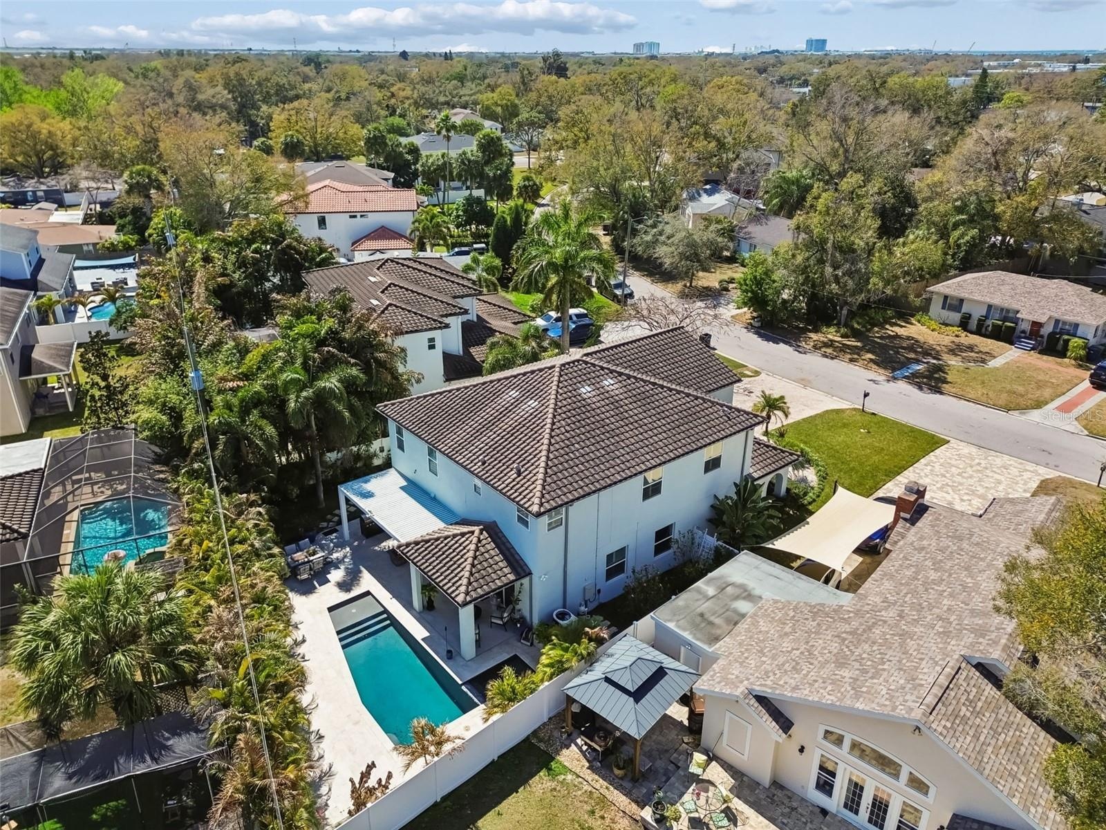 Aerial view of the house, showcasing the expansive backyard and surrounding landscape.