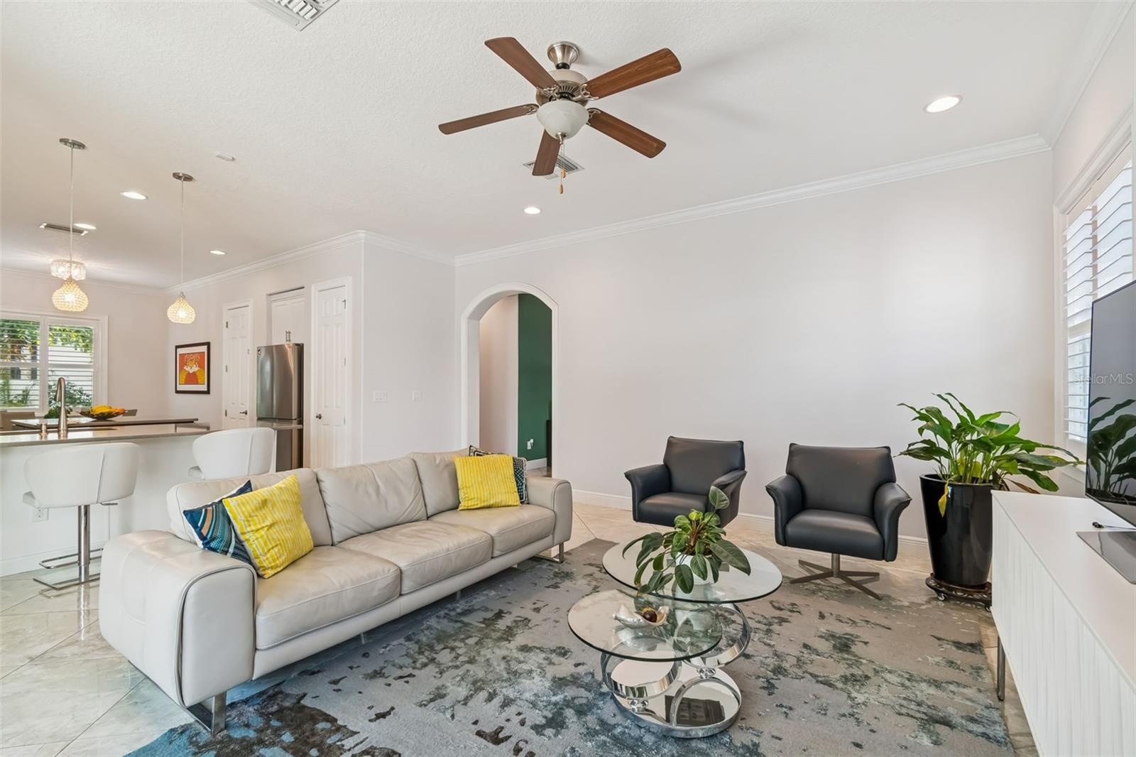 The living room opens to the kitchen, keeping both spaces connected.