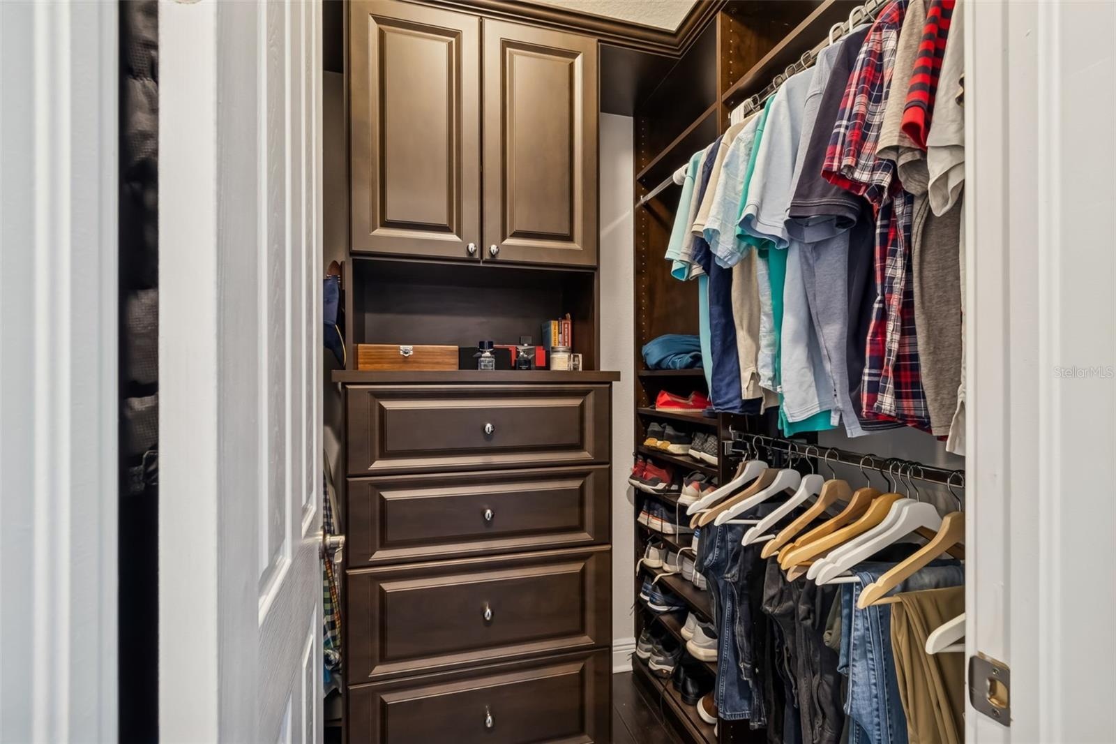 One of two primary suite closets, fitted with custom cabinetry and organizers.