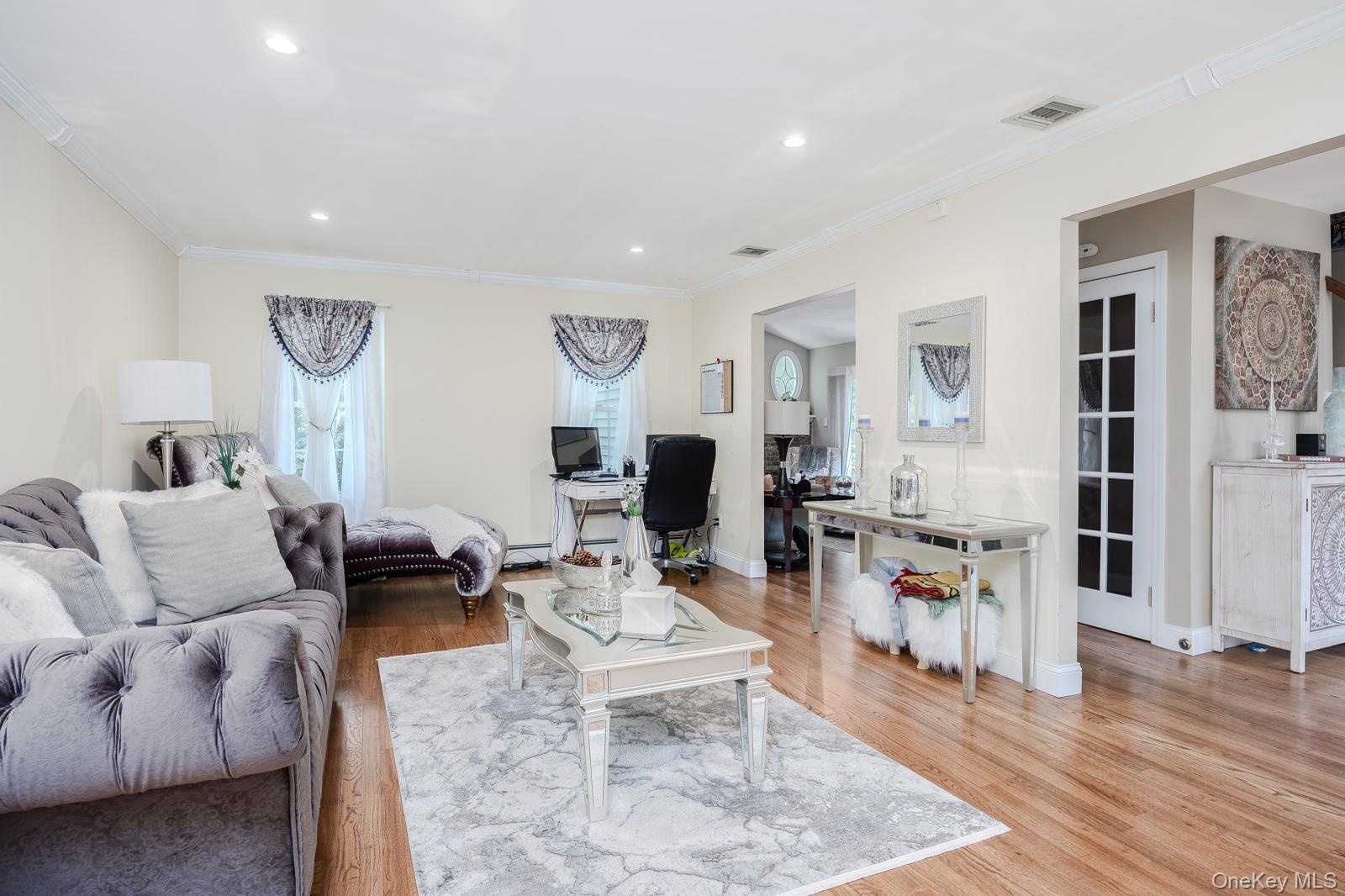 Hardwood-finish flooring, recessed lighting, crown molding, and decorative interior doors