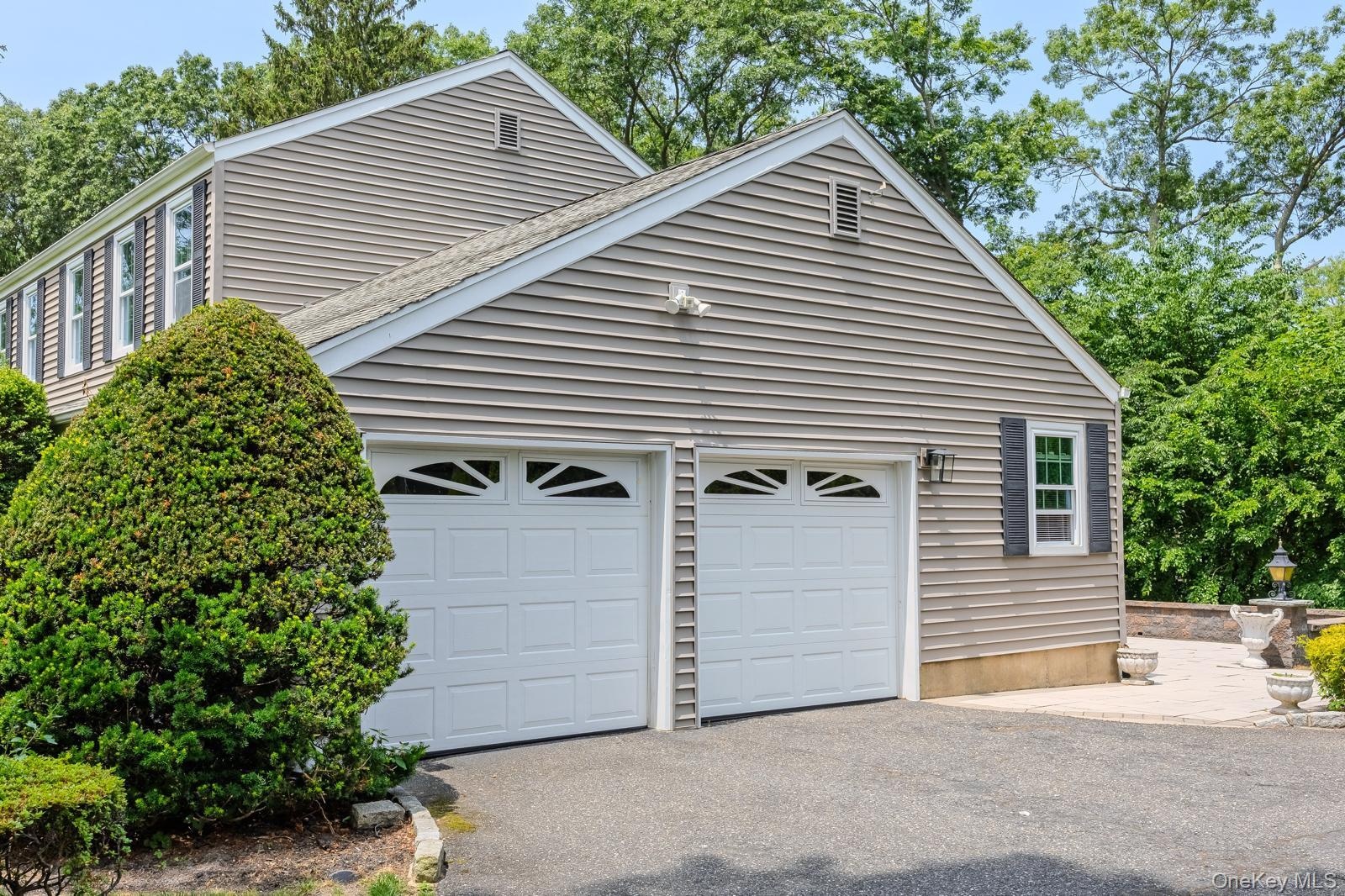 Two-car garage with white paneled automation doors