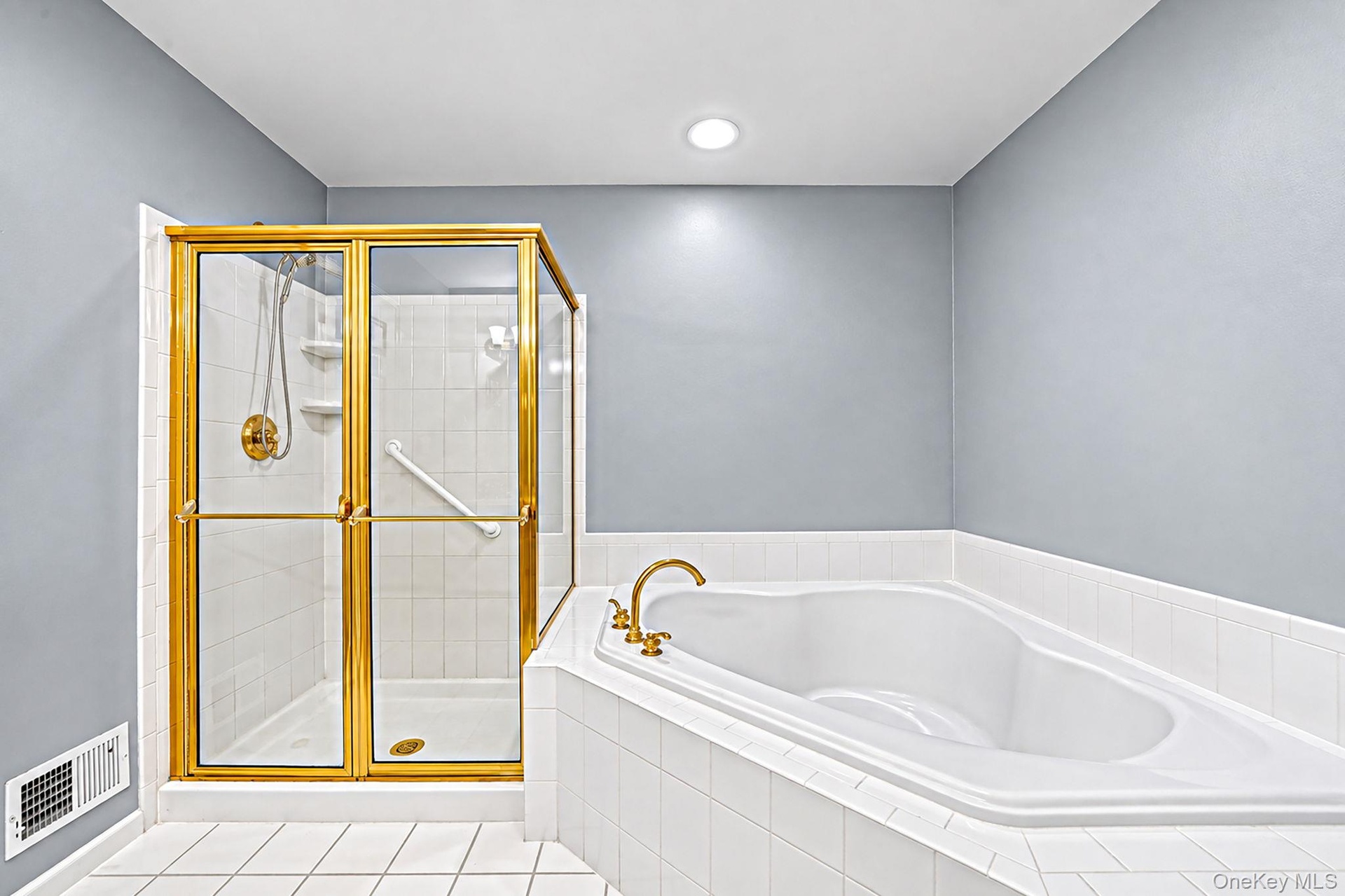 Primary bathroom with shower stall and large tub
