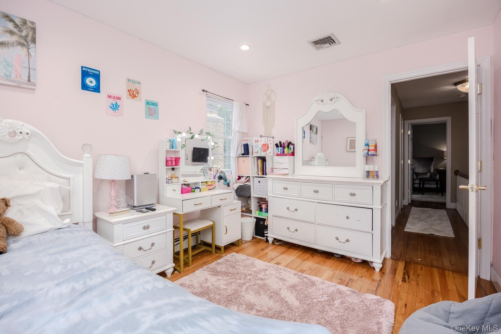Bedroom 3 recessed ceiling lighting, wood-finish flooring, and a window with natural light