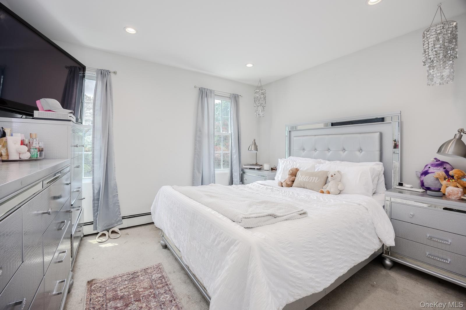 Bedroom 2 recessed lighting, two windows with natural light, and two decorative ceiling fixtures