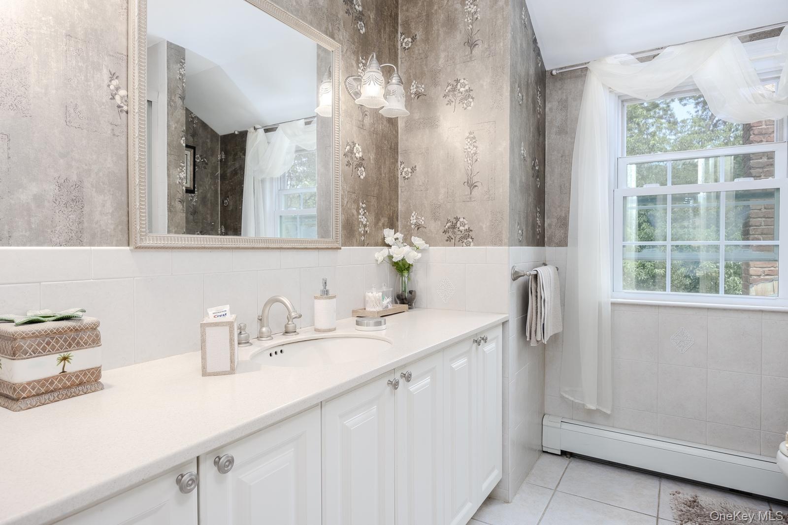 Dual-basin vanity with ample counter space, integrated sink, and white cabinetry