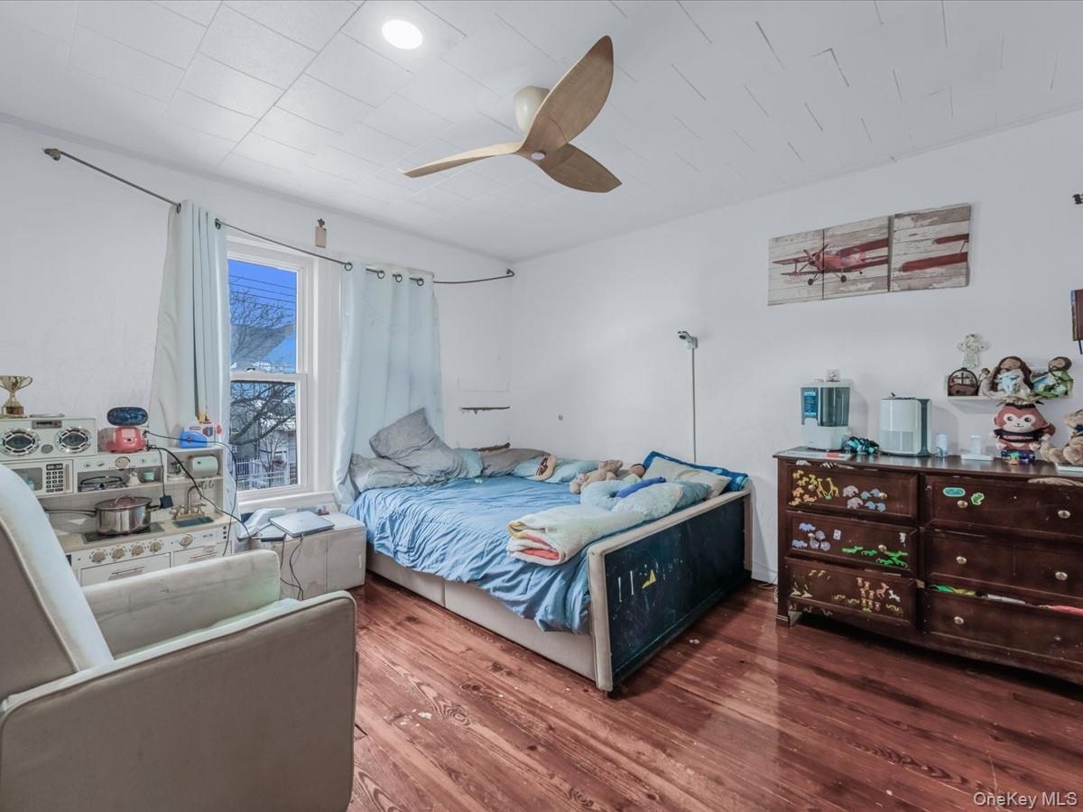 Bedroom with wood finished floors and ceiling fan