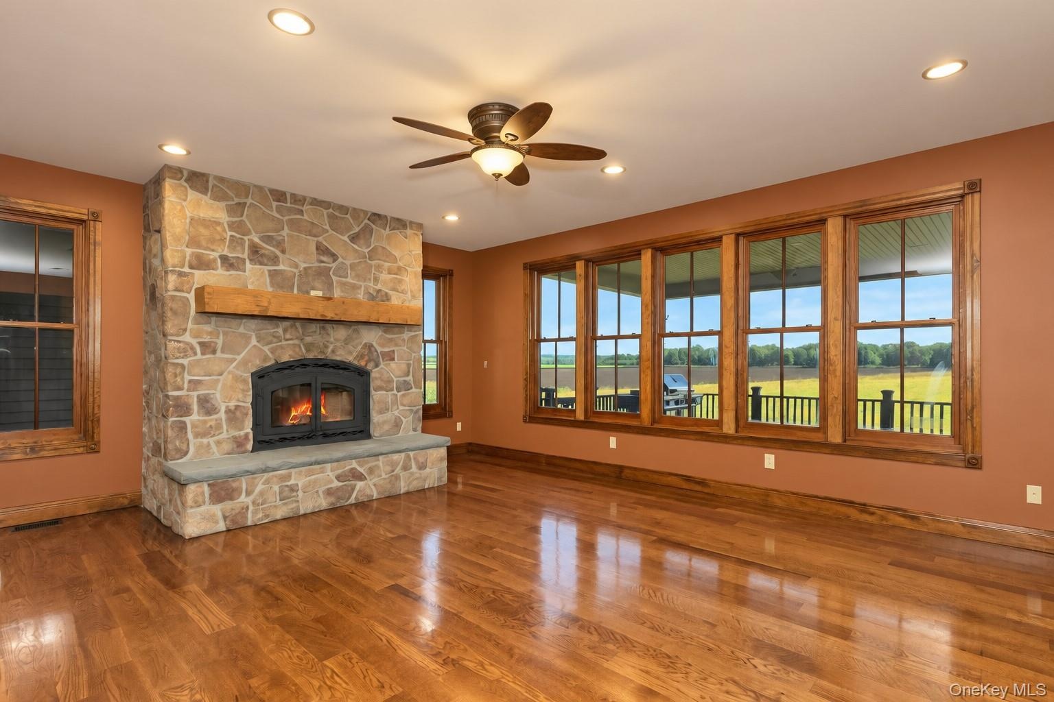 Stone-clad fireplace with a wood mantel and hearth