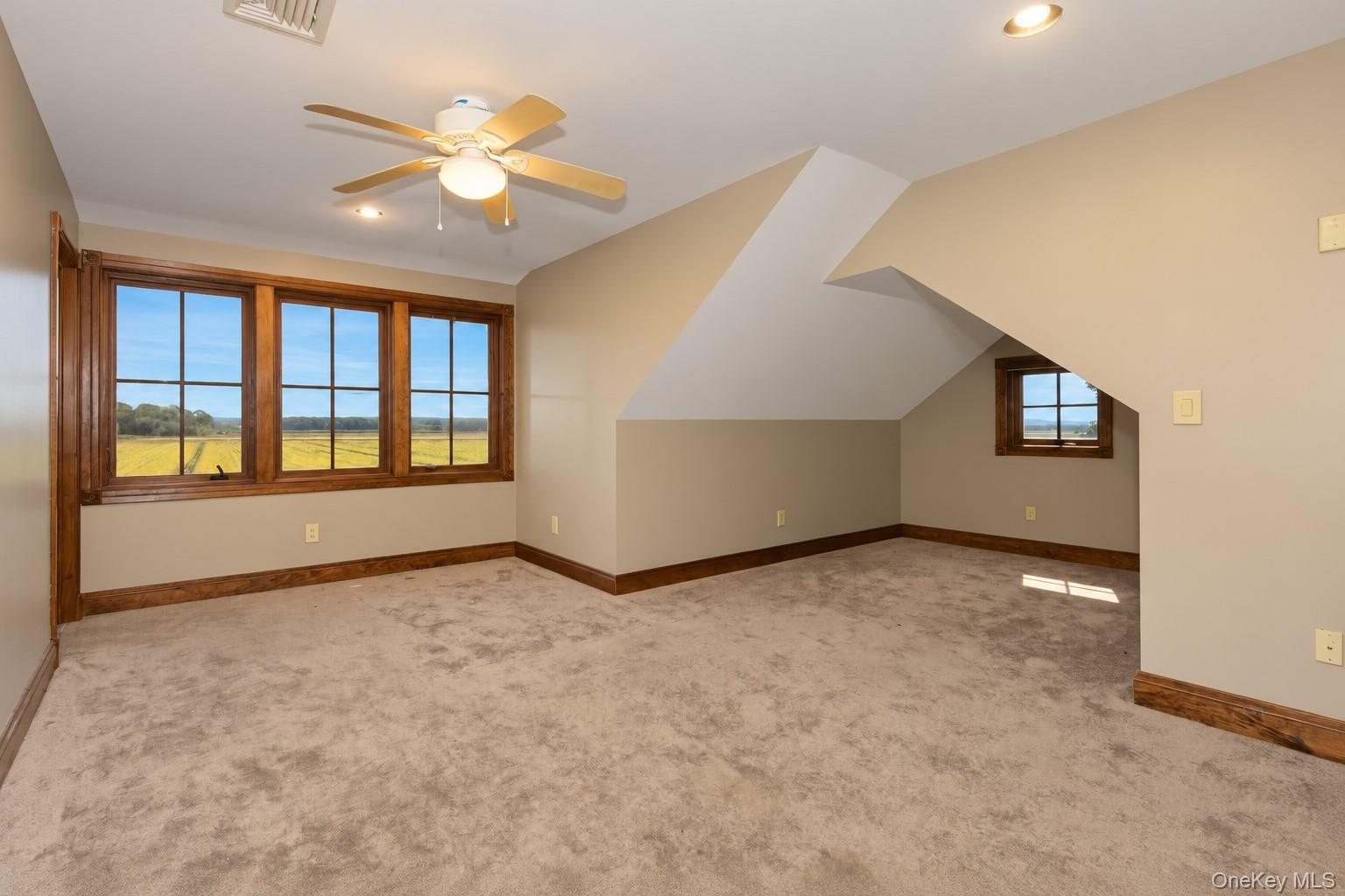 Wall-to-wall carpeting, recessed lighting, and a ceiling fan with light fixture