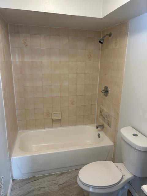 Bathroom with toilet and shower / bathtub combination
