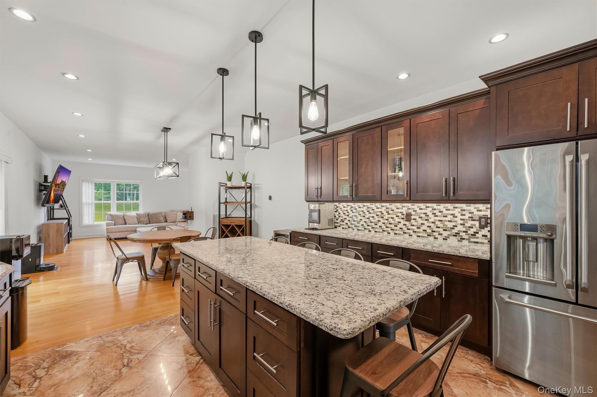Kitchen with 7 foot 7 inch center island that seats 6, Cafe appliances, granite countertops, tile backsplash, uplighting, Recessed lighting, marble ti