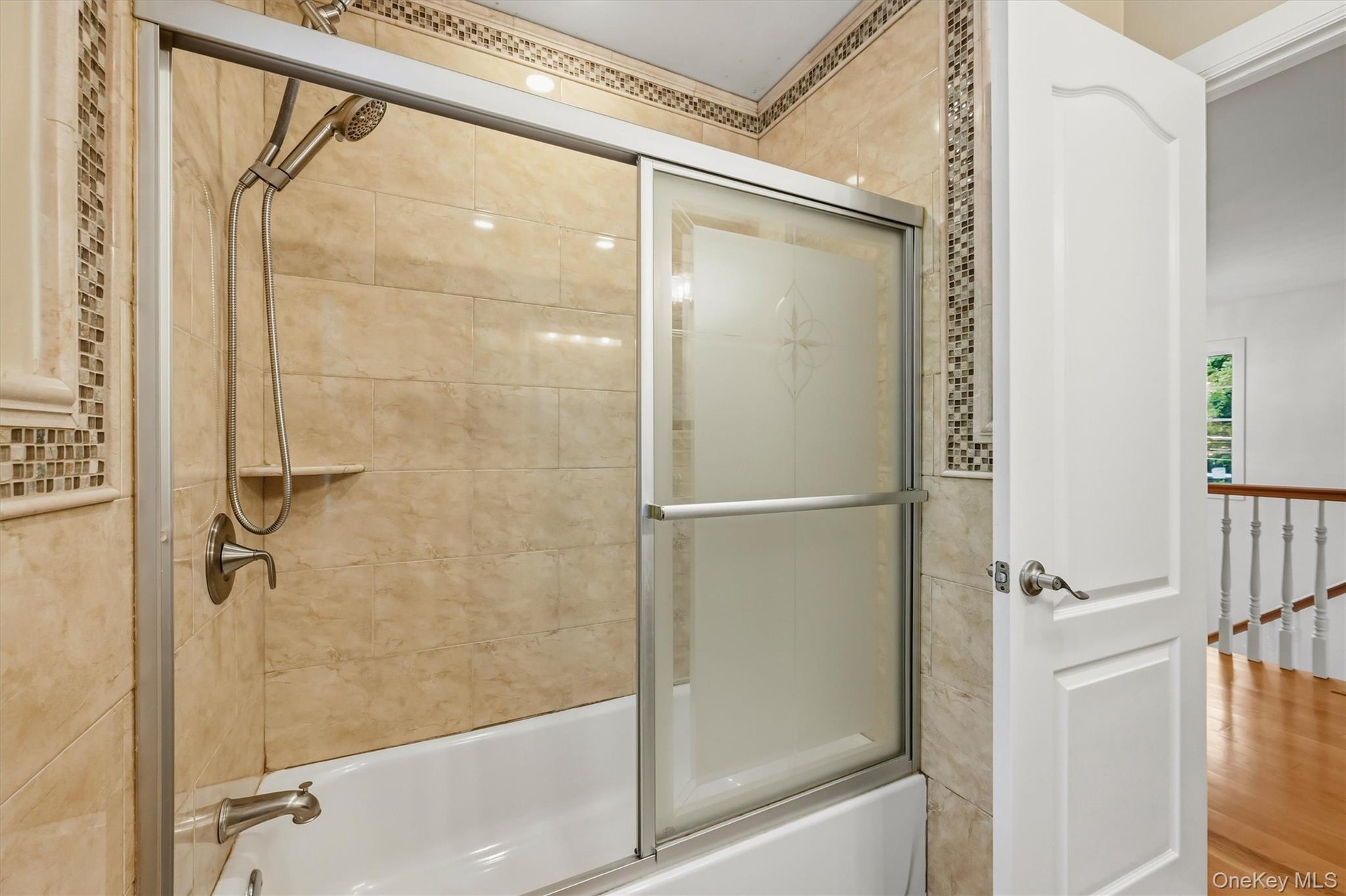 Hallway bathroom, marble tile, Anderson window, recessed lighting.