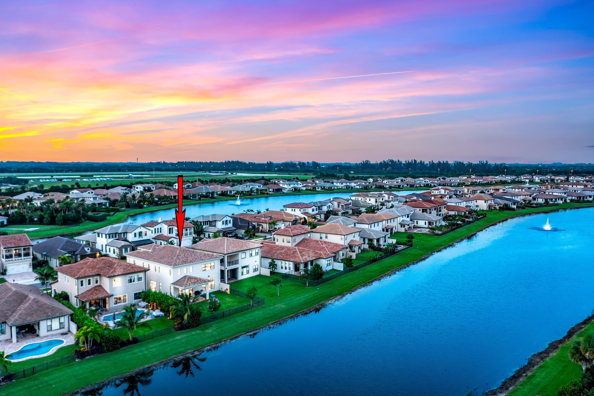 Waterside property with a private pool, covered patio, and terracotta roof tiles