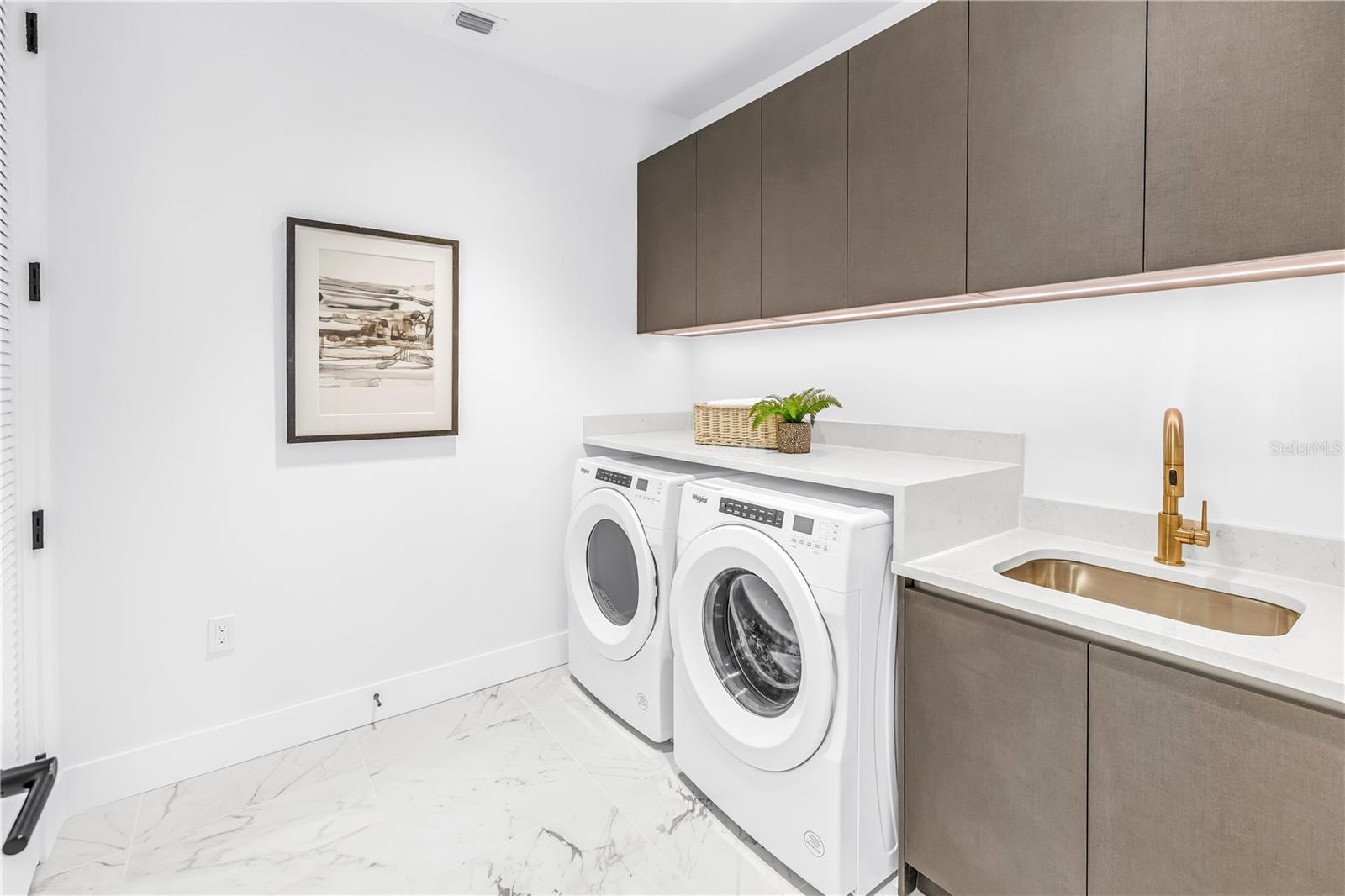 laundry room, additional closet for storage , laundry sink and upper cabinets