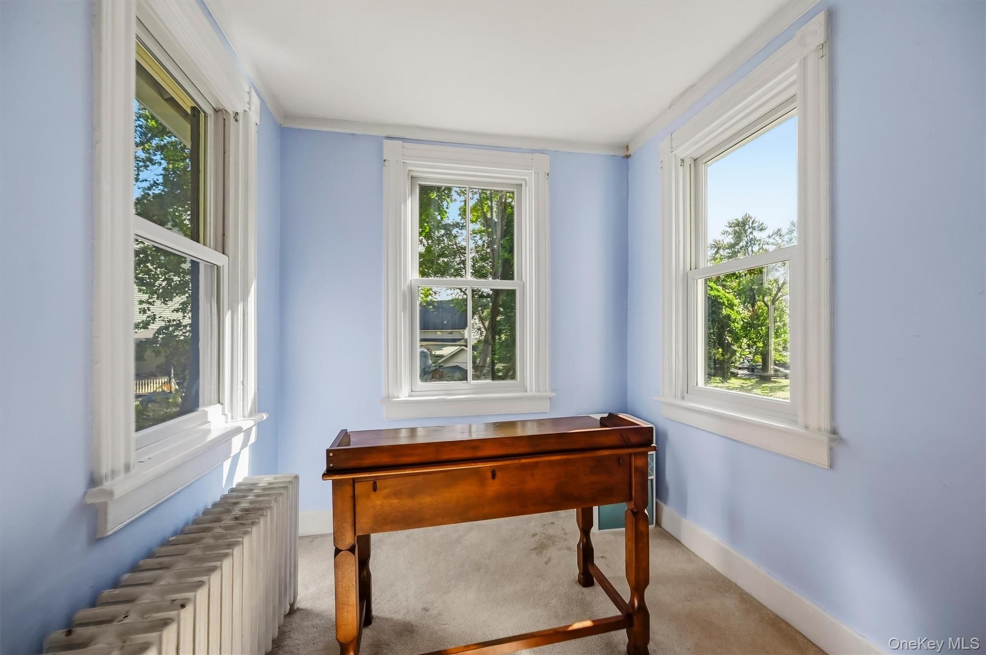Bright sitting area with windows on three sides and plenty of natural light
