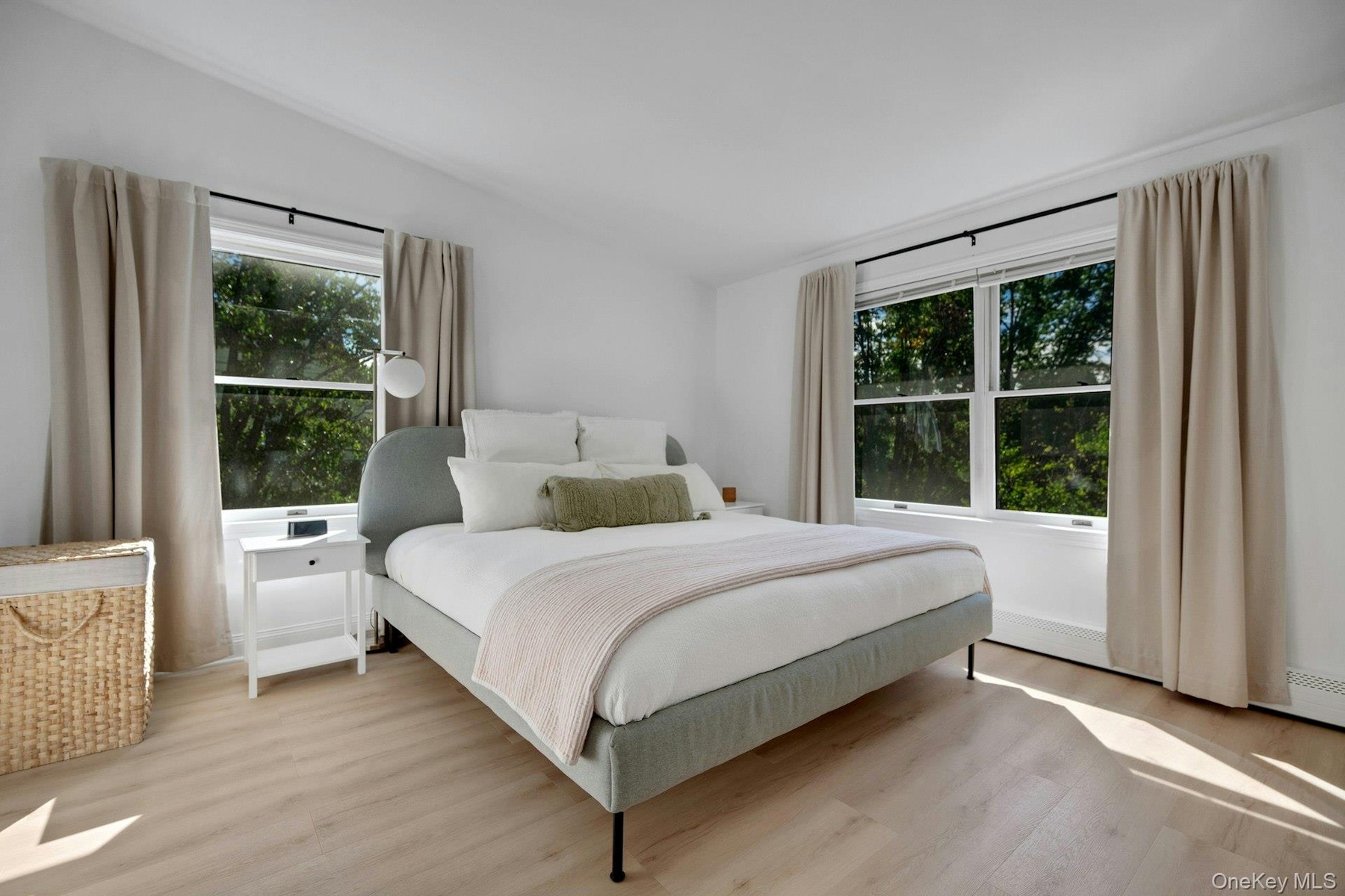 Spacious bright primary suite with seasonal views of bridge...