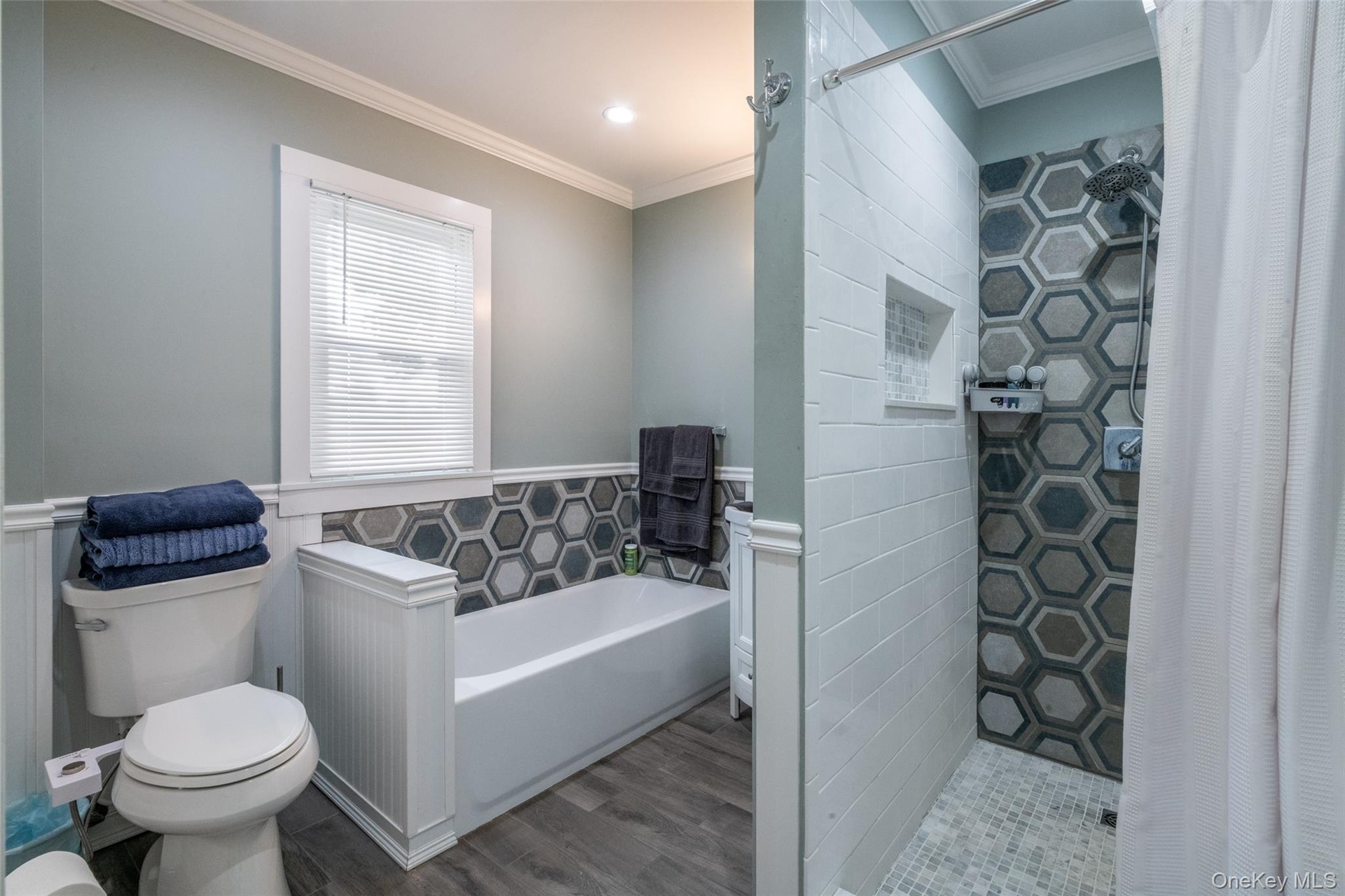 Spacious bathroom with separate tub and shower stall.