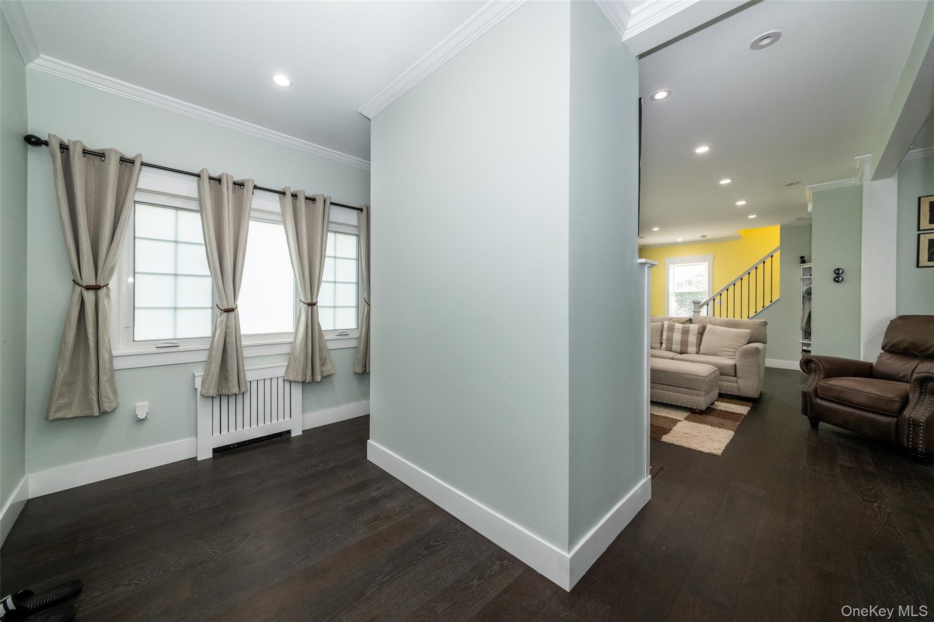 off livingroom behind fpl, door to breezeway and paver patio, yard and garage