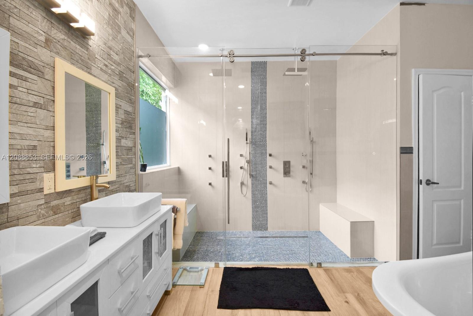 Primary bathroom featuring dual vanities and a dual rainfall walk-in shower