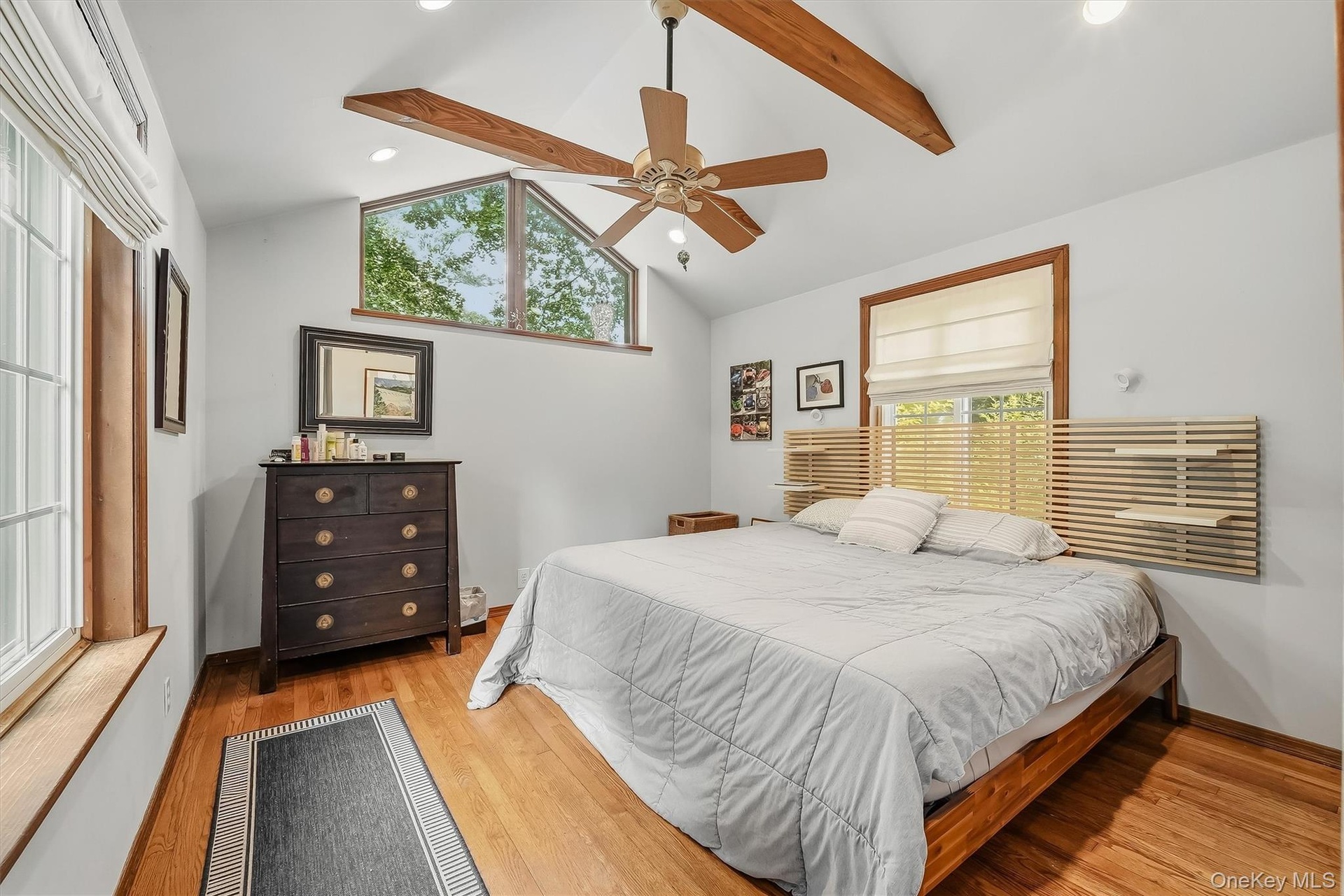 The oversized primary bedroom features custom windows, cathedral ceilings and is large enough for a king size bed.