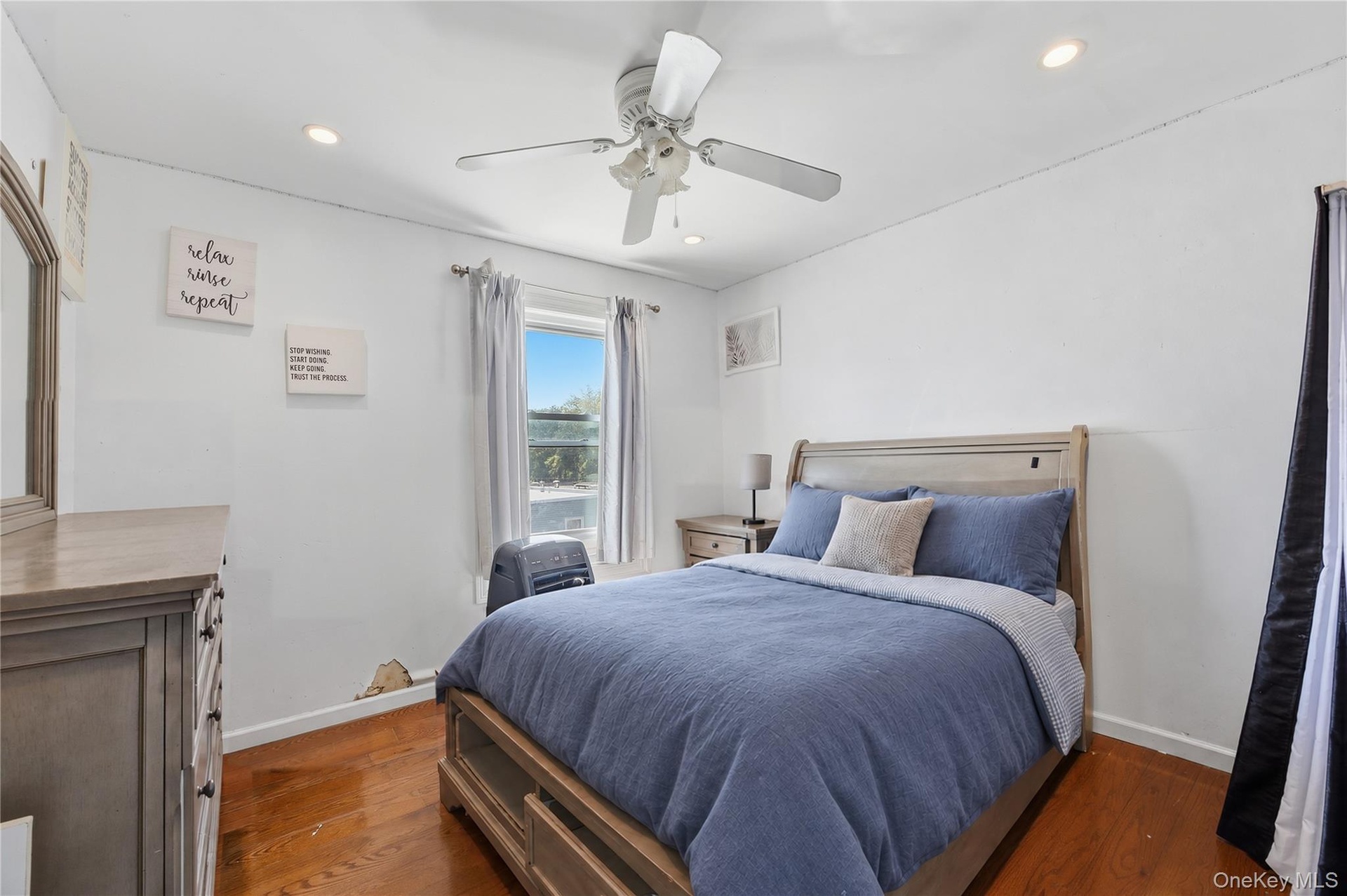 Unit 2 - Bedroom 2. Digitally decluttered; bedding and decor restyled.