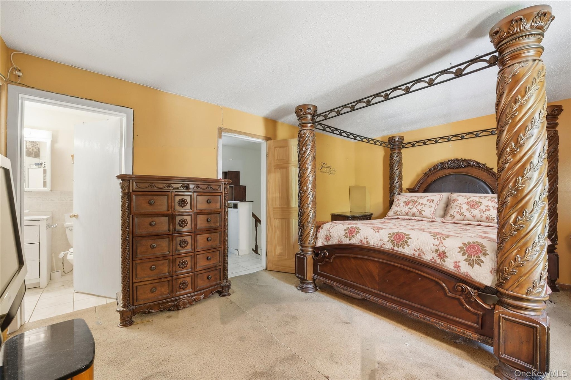 Unit 2 - Primary bedroom, reverse view. Digitally decluttered; bedding and decor restyled.