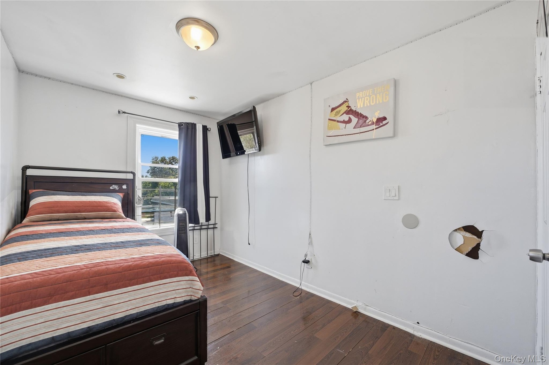 Unit 2 - Bedroom 3, reverse view. Digitally decluttered; bedding and decor restyled.